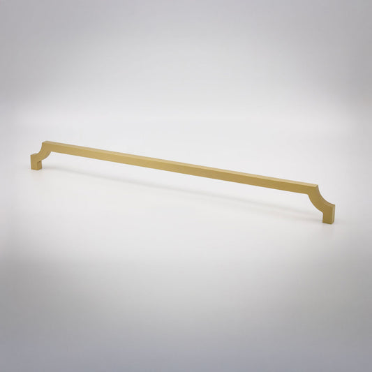 A long, slender cabinet pull in a satin brass finish shown against a neutral background.
