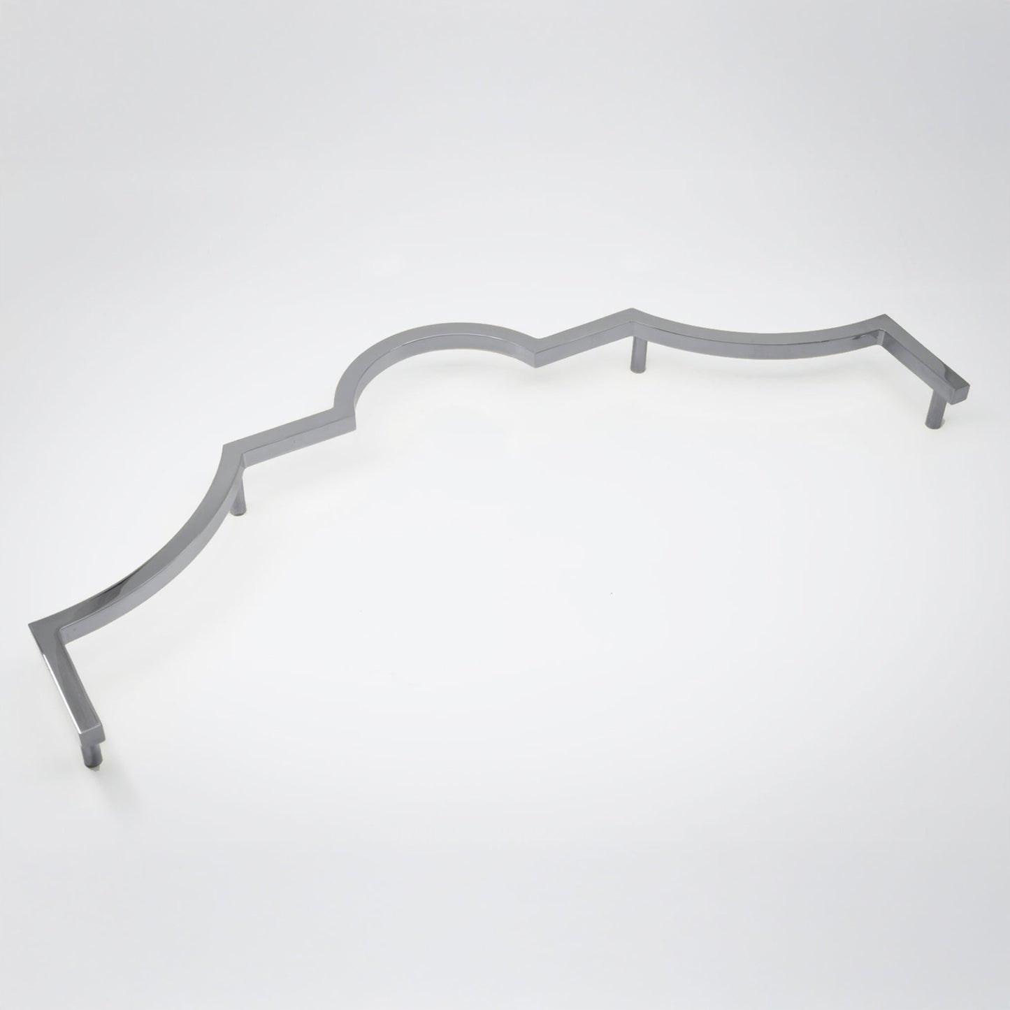 A long decorative cabinet pull handle with a wavy scalloped edge, in a polished chrome finish shown on a clean light gray studio background.