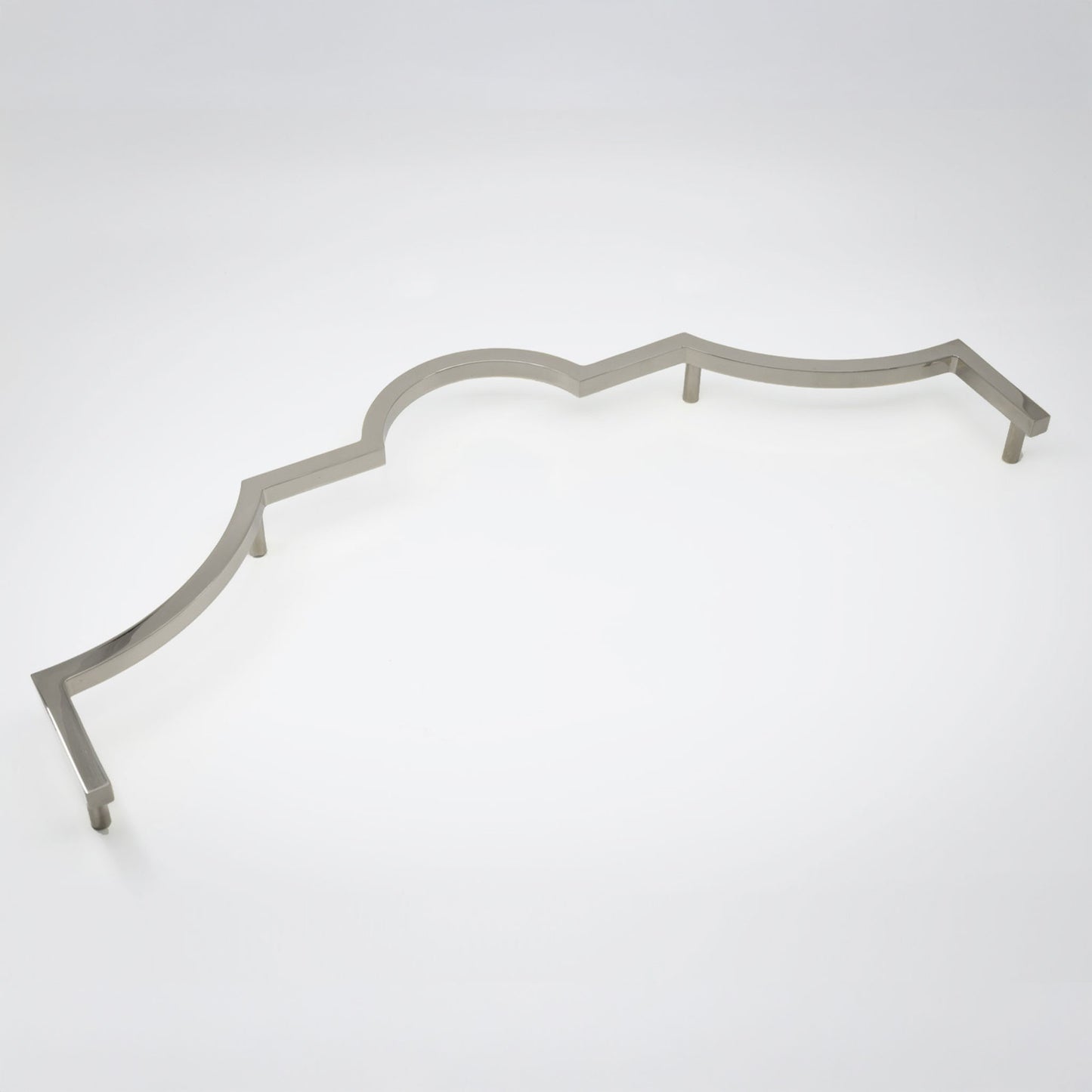 A long decorative cabinet pull handle with a wavy scalloped edge, in a polished nickel finish shown on a clean light gray studio background.