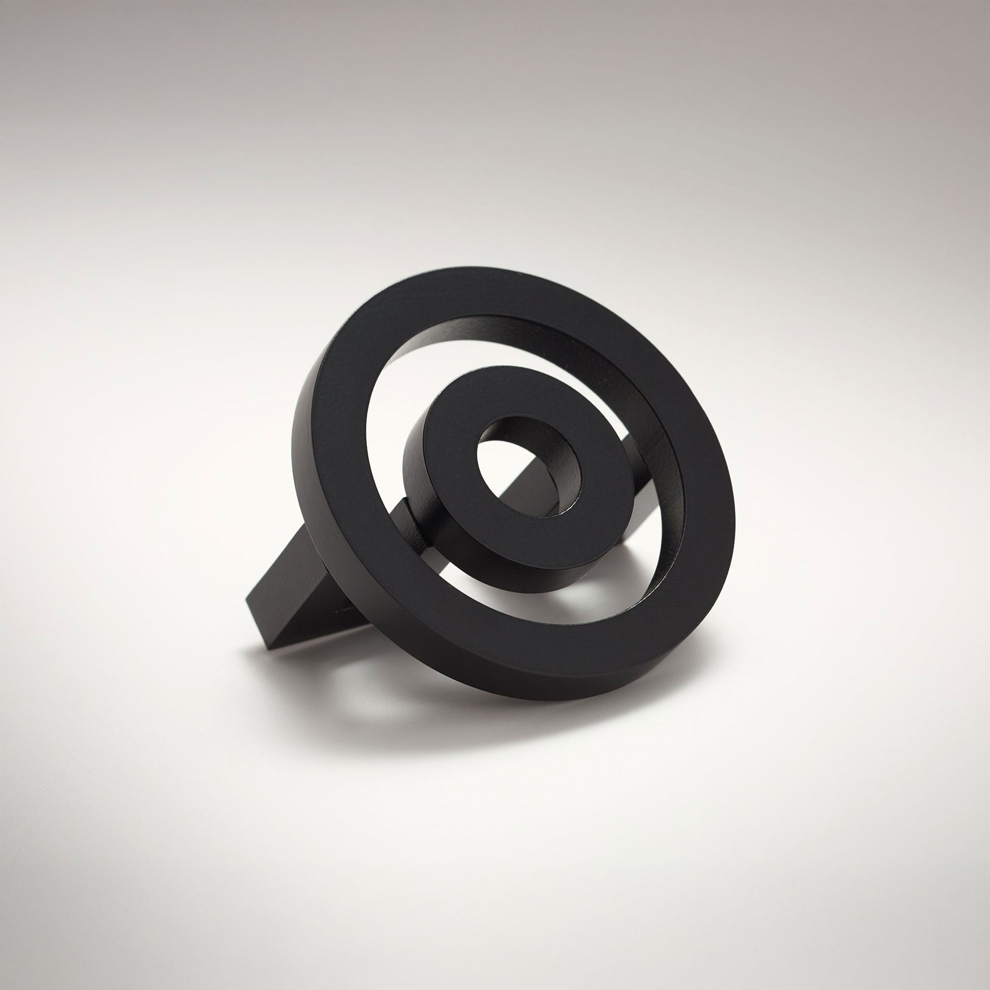 Concentric circle shaped cabinet knob on a grey background