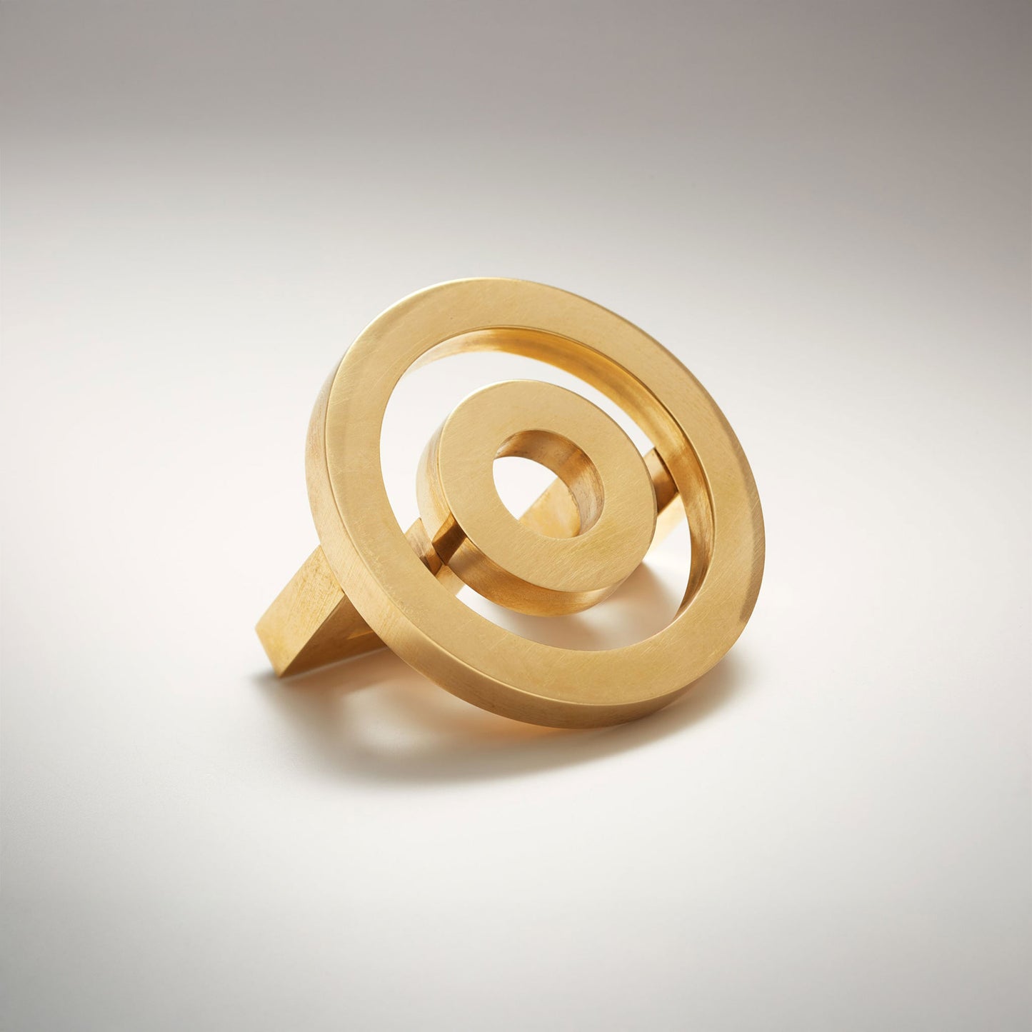 Concentric circle shaped cabinet knob on a grey background