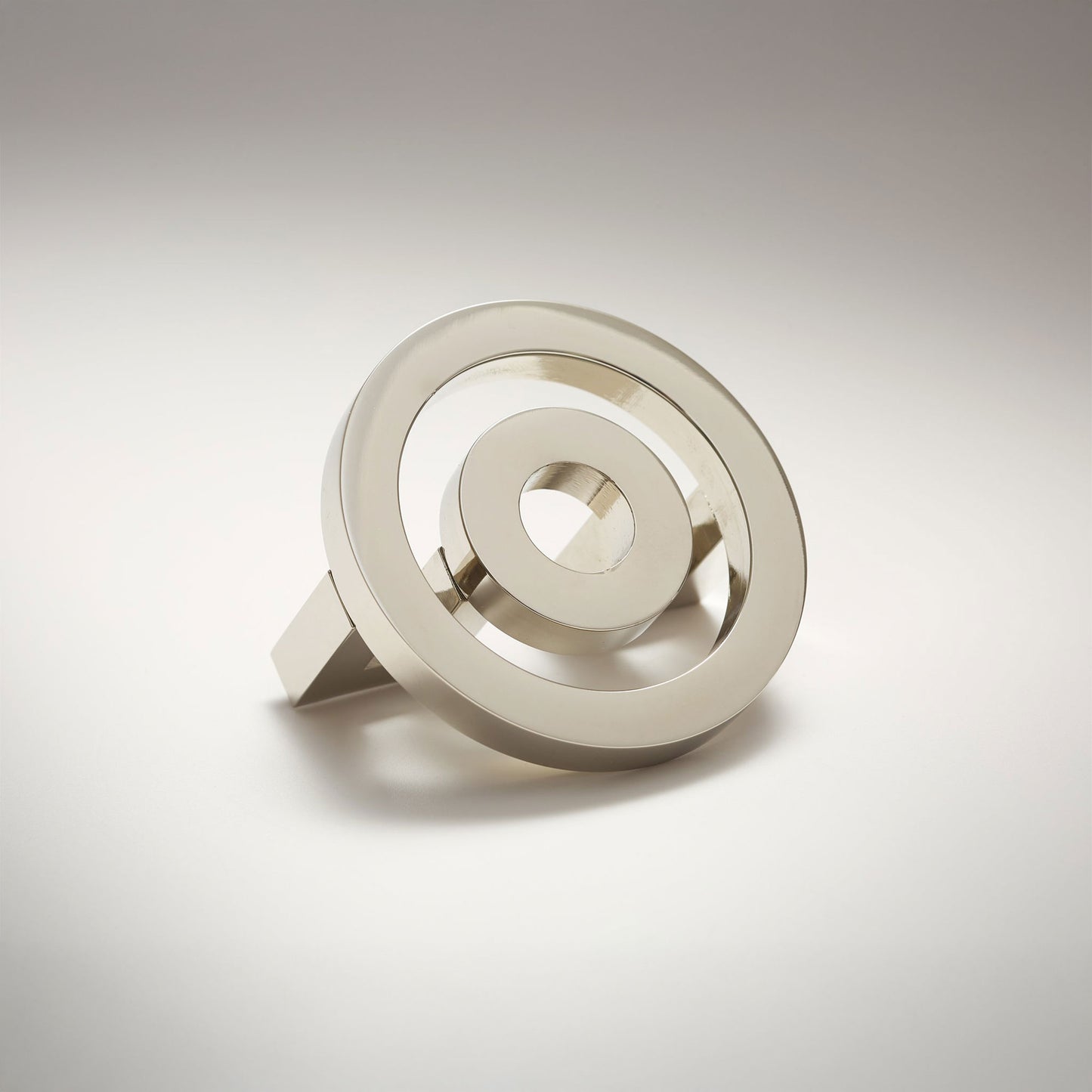 Concentric circle shaped cabinet knob on a grey background