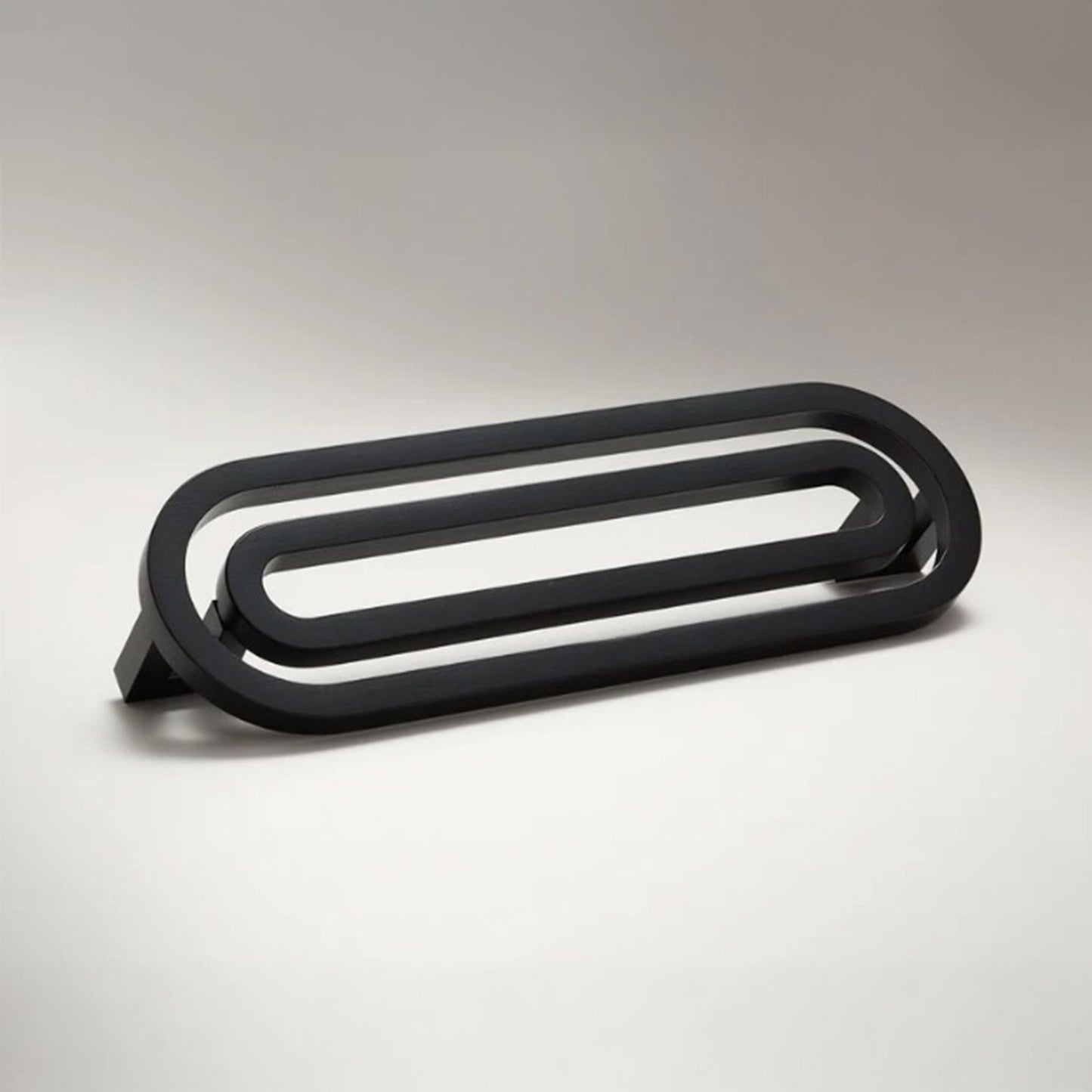 Pill shaped cabinet pull on a grey background