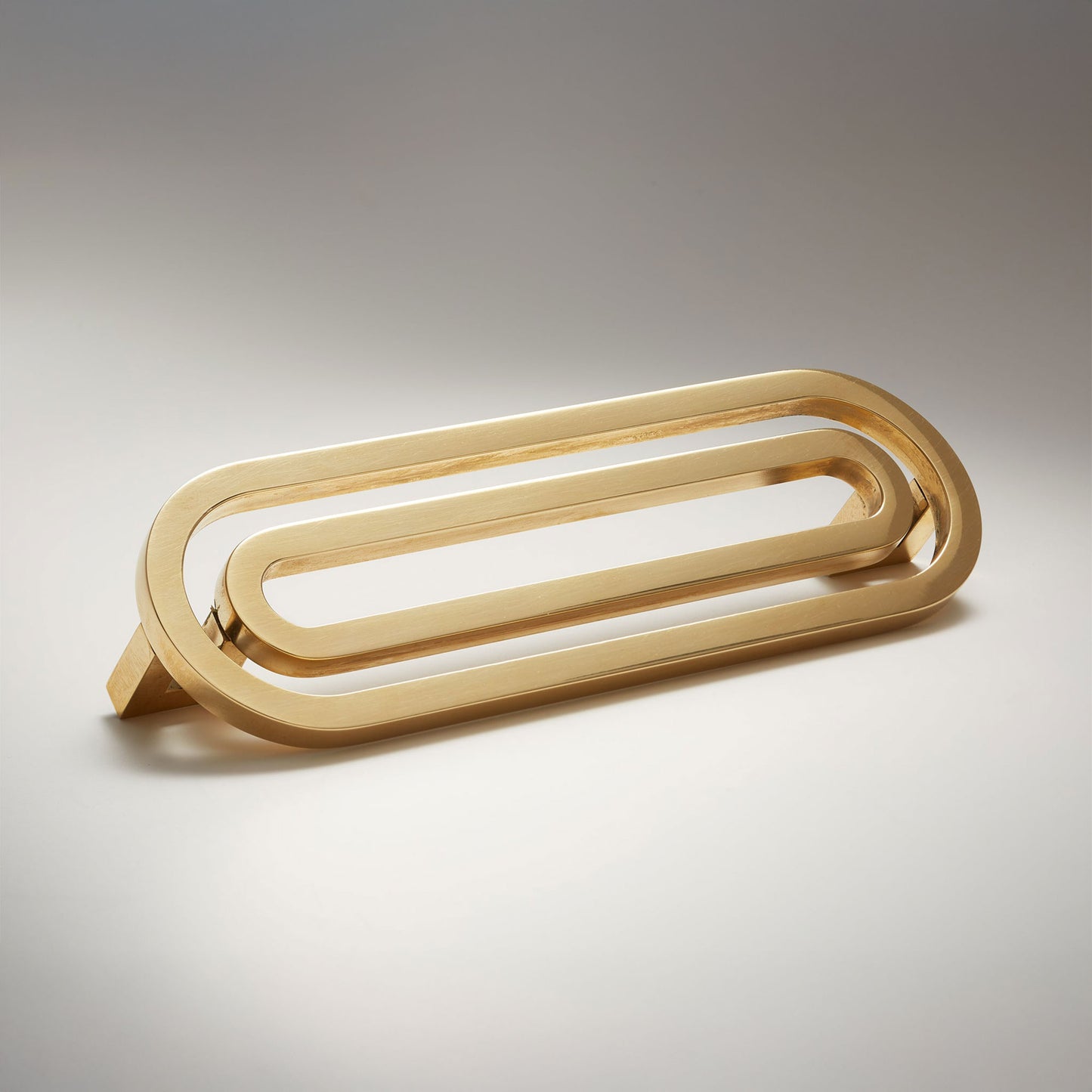 Pill shaped cabinet pull on a grey background