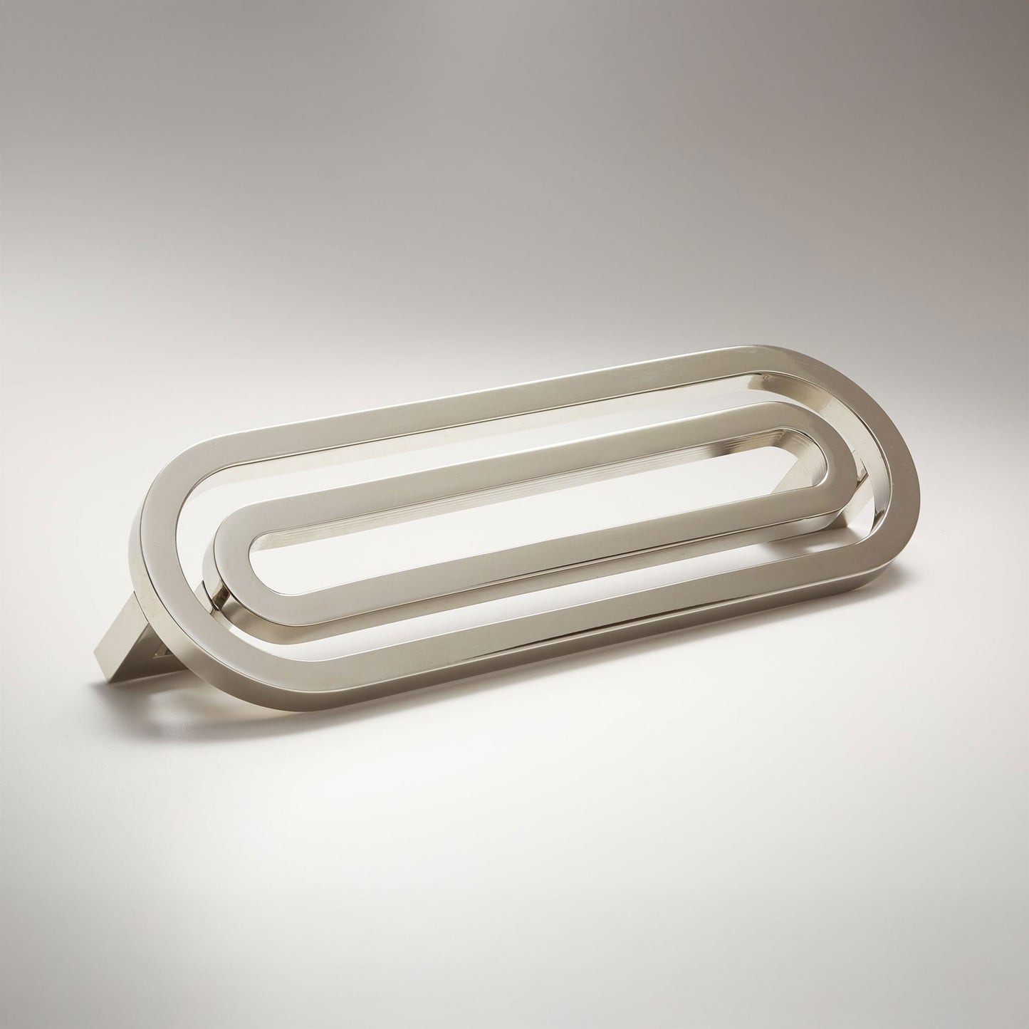 Pill shaped cabinet pull on a grey background