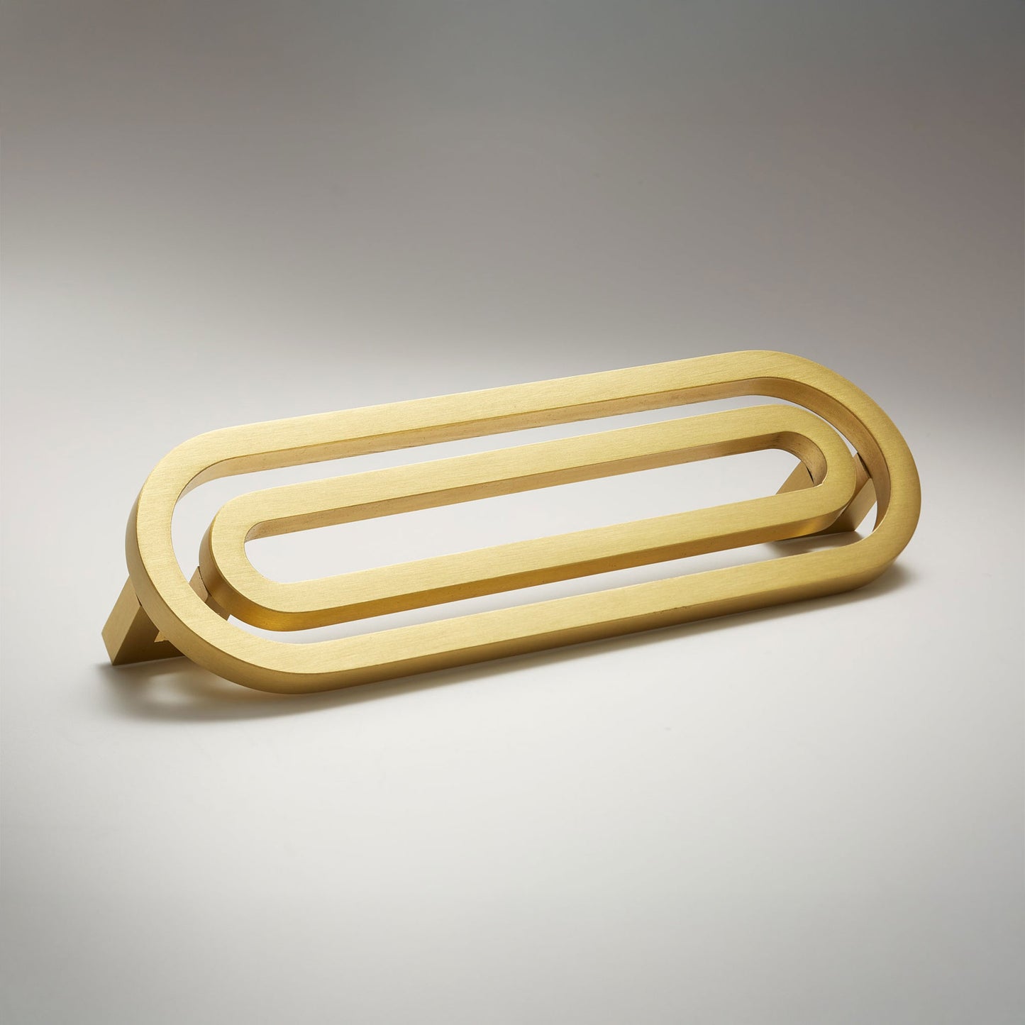 Pill shaped cabinet pull on a grey background