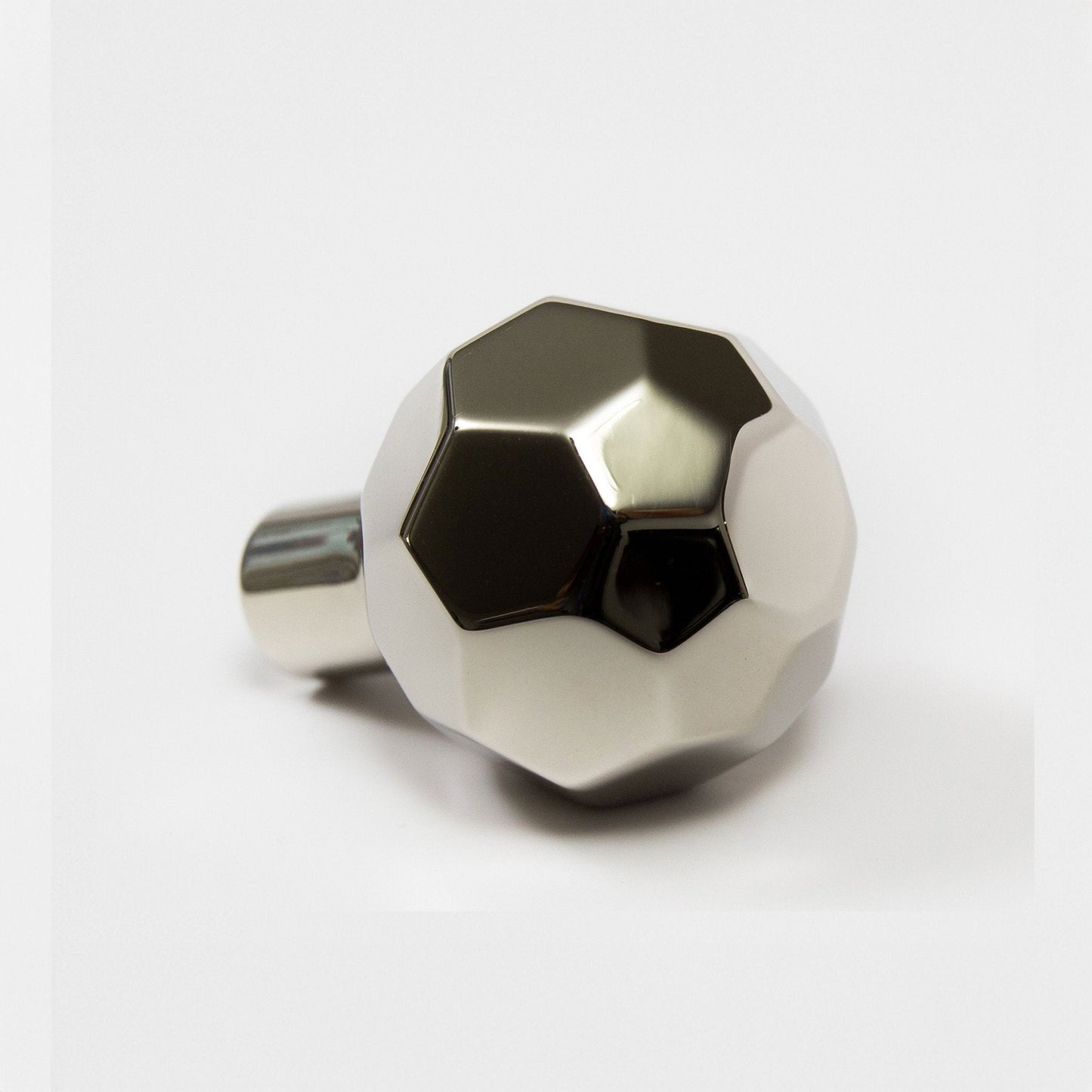 A metallic polished nickel ball-shaped cabinet knob with a faceted design and a cylindrical mounting stem, shown on a clean white background.