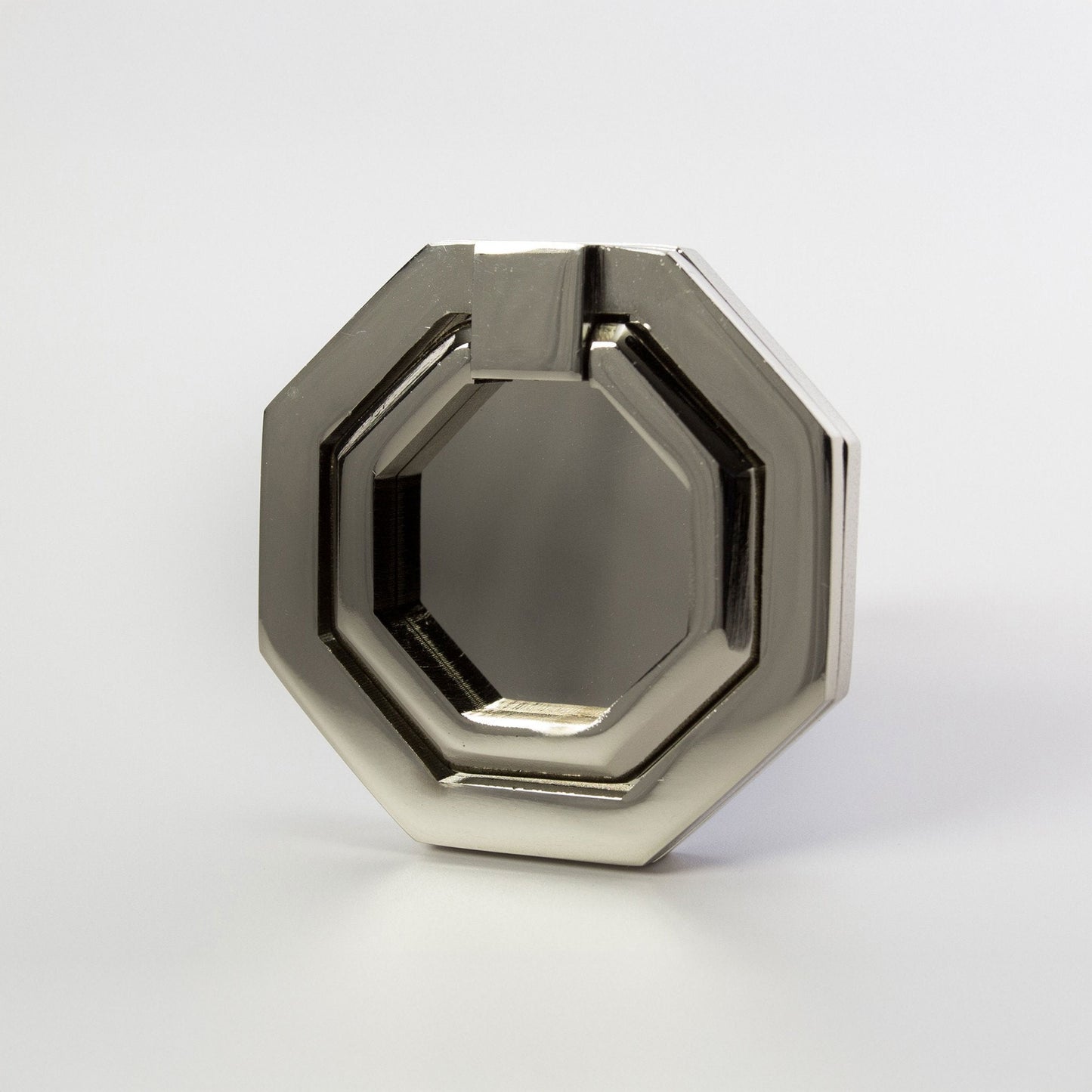 An octagonal metal ring cabinet pull with a polished nickel finish, photographed on a clean light gray background.