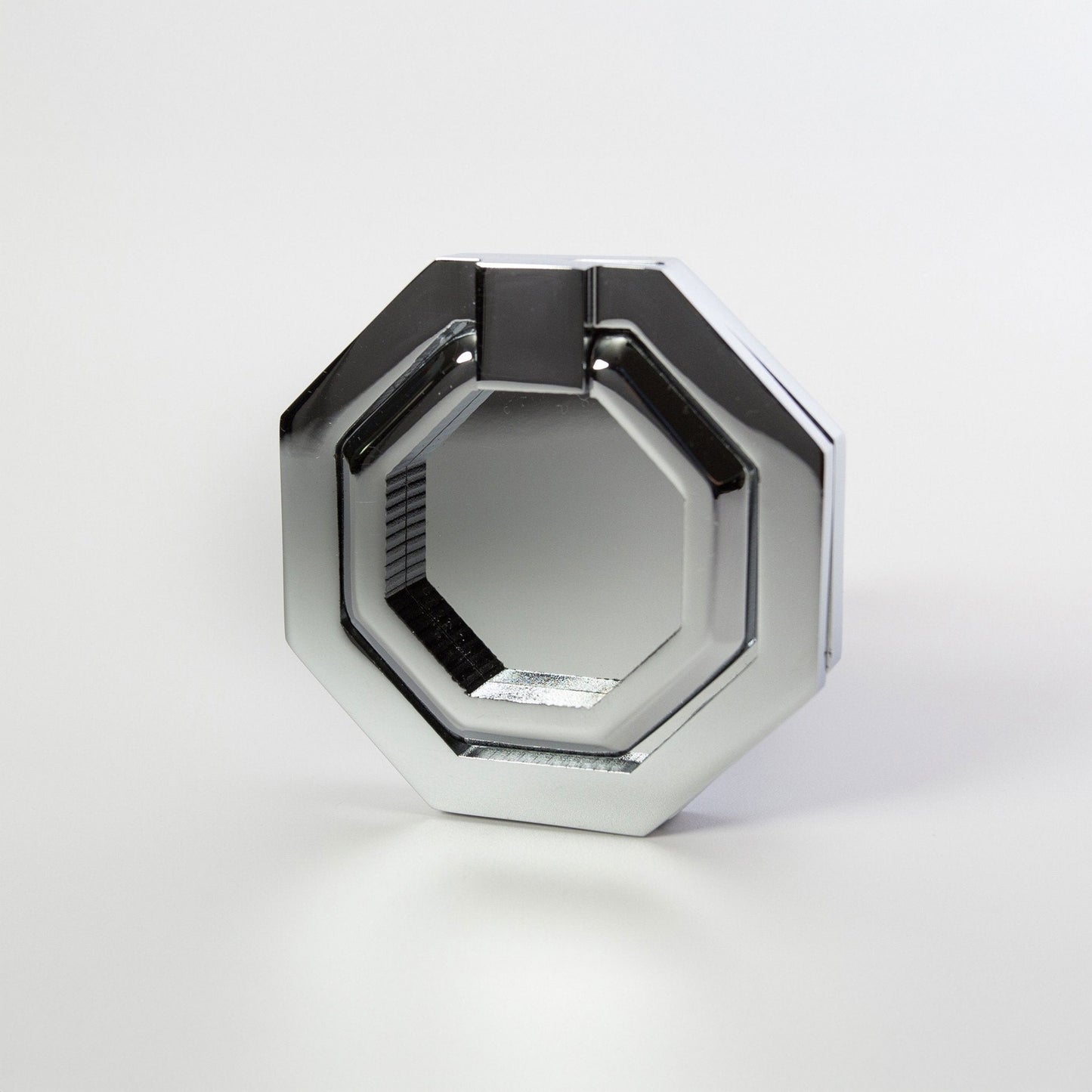 An octagonal metal ring cabinet pull with a polished chrome finish, photographed on a clean light gray background.
