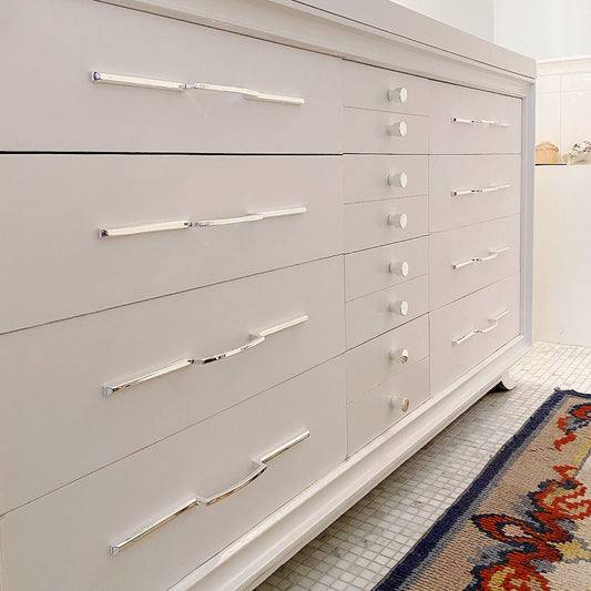 Long Arm Mid Century Modern Pulls installed on a bathroom cabinet