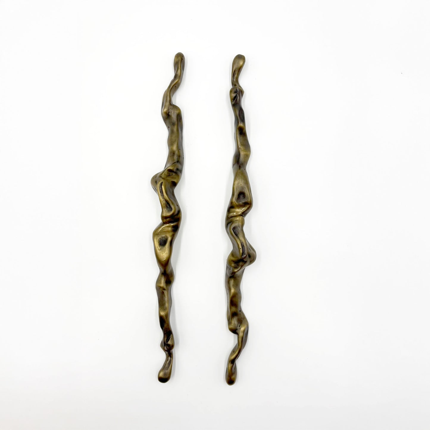 Two abstract, wavy metal cabinet handles with a distressed bronze finish, displayed vertically on a plain white background.