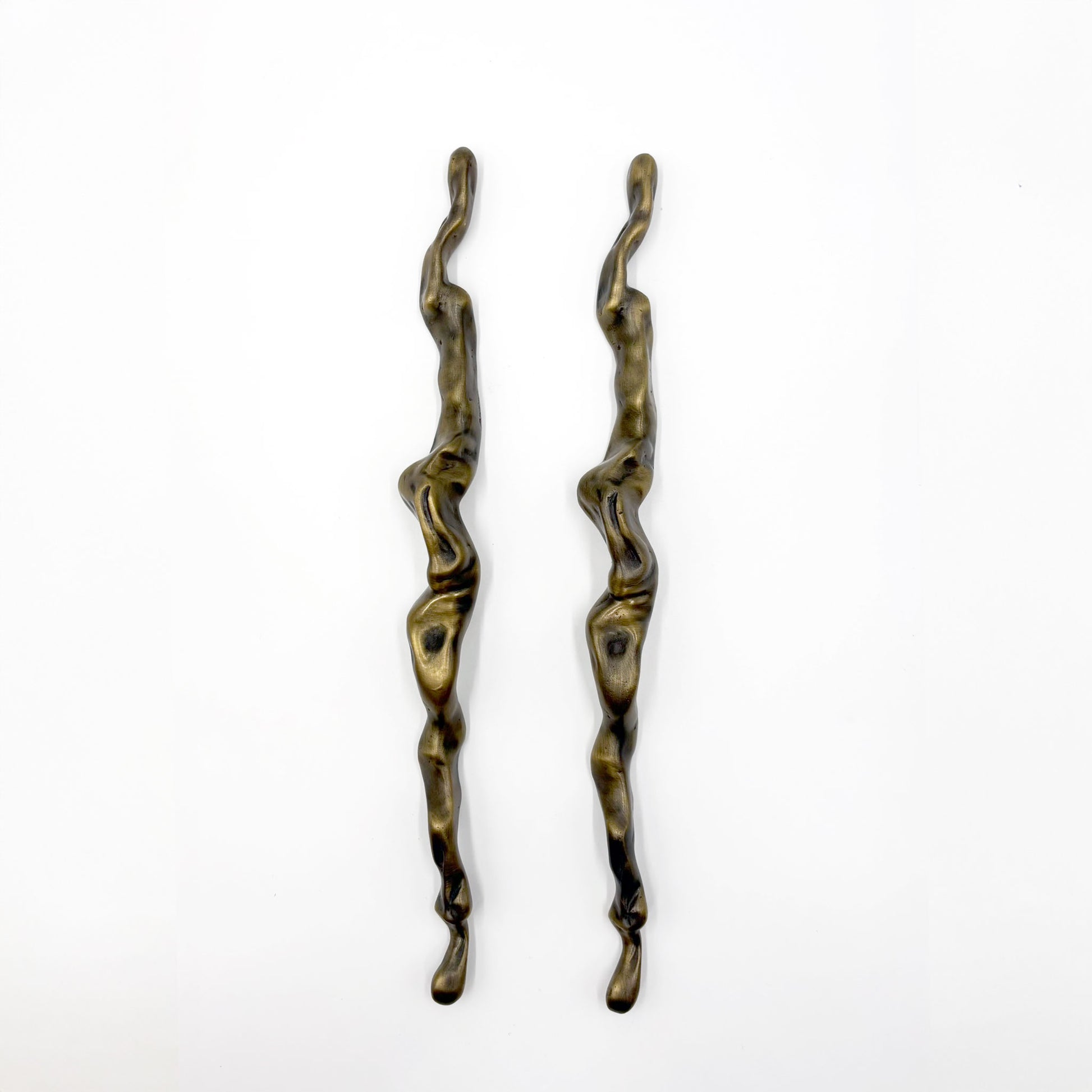 Two abstract, wavy metal cabinet handles with a distressed bronze finish, displayed vertically on a plain white background.