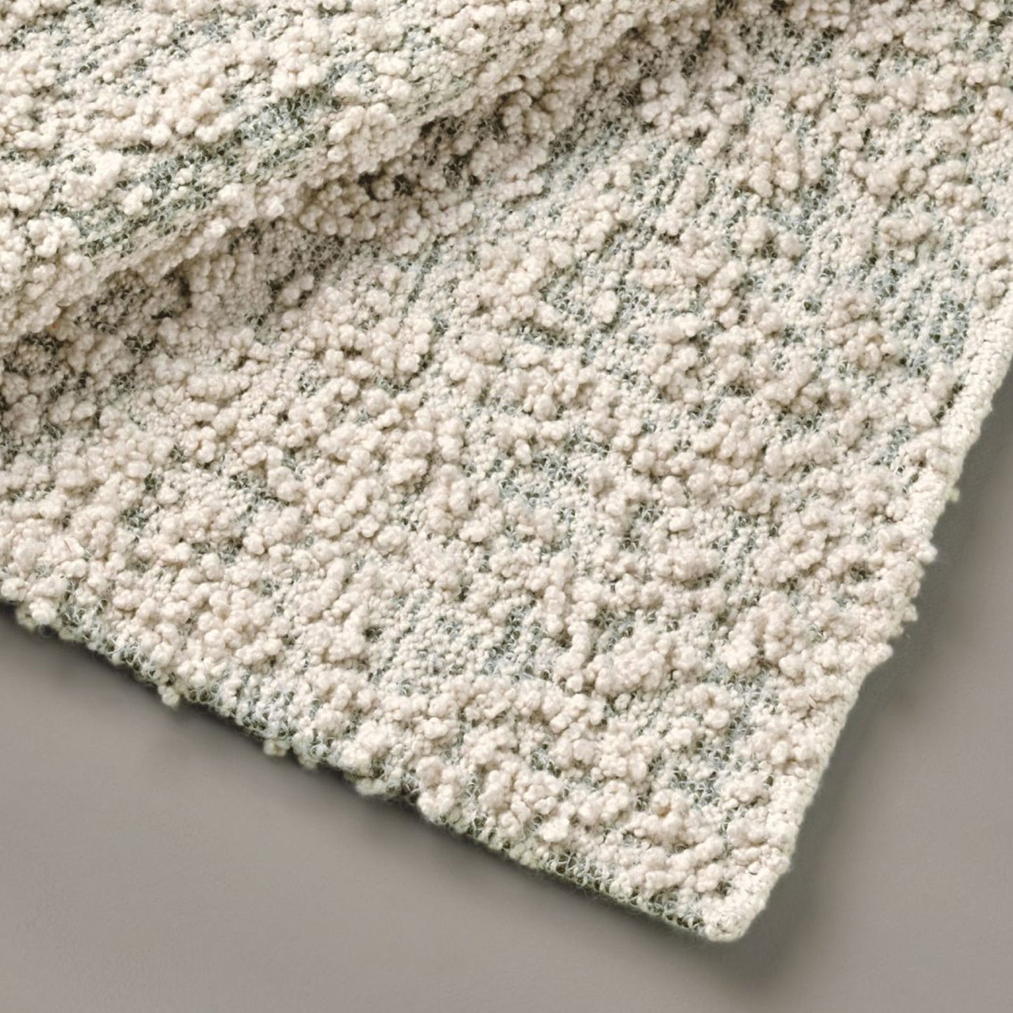 Fiore rug style in cream and dark green colored boucle weave