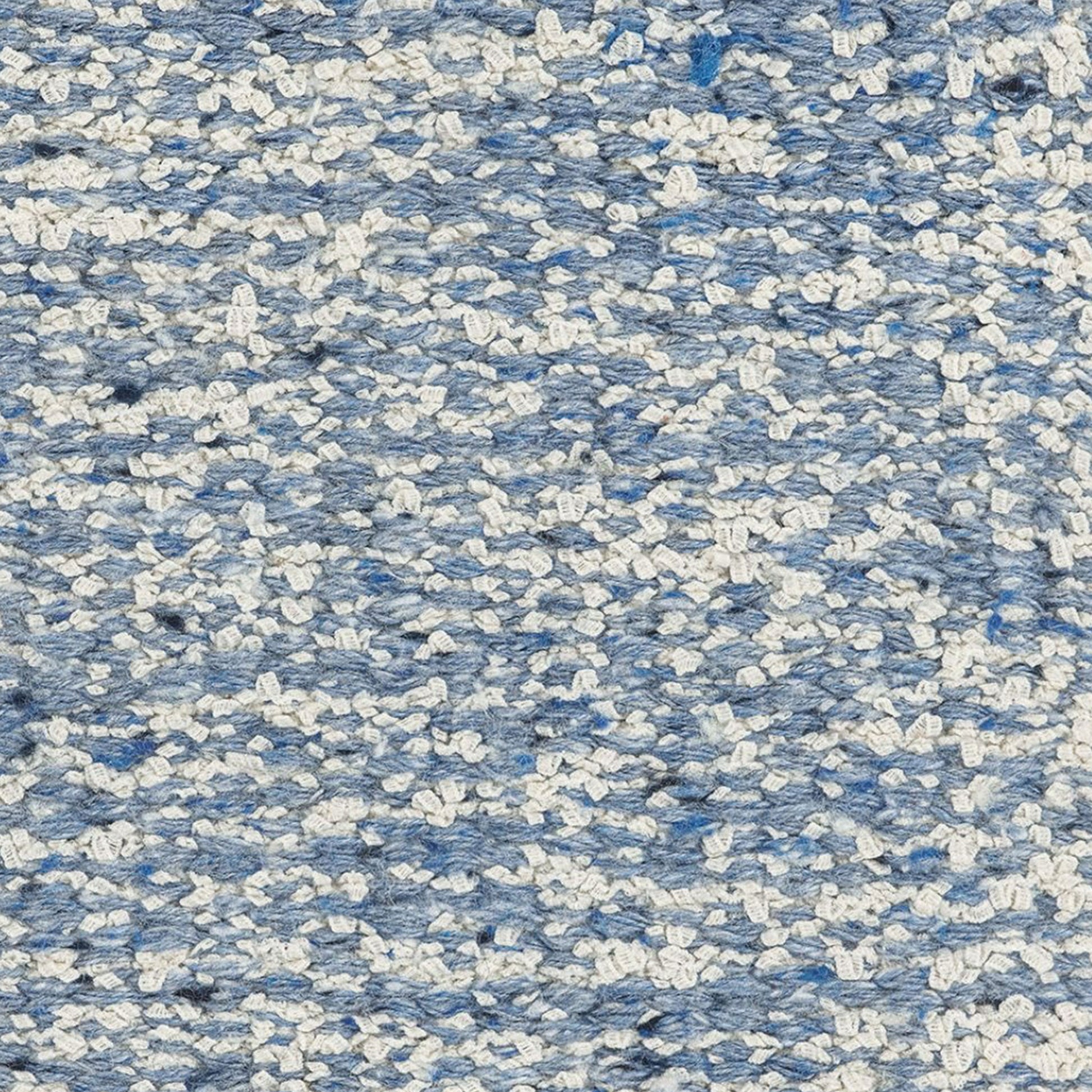 close up of Iris rug style in off white and light blue colored mottled twisted flat weave