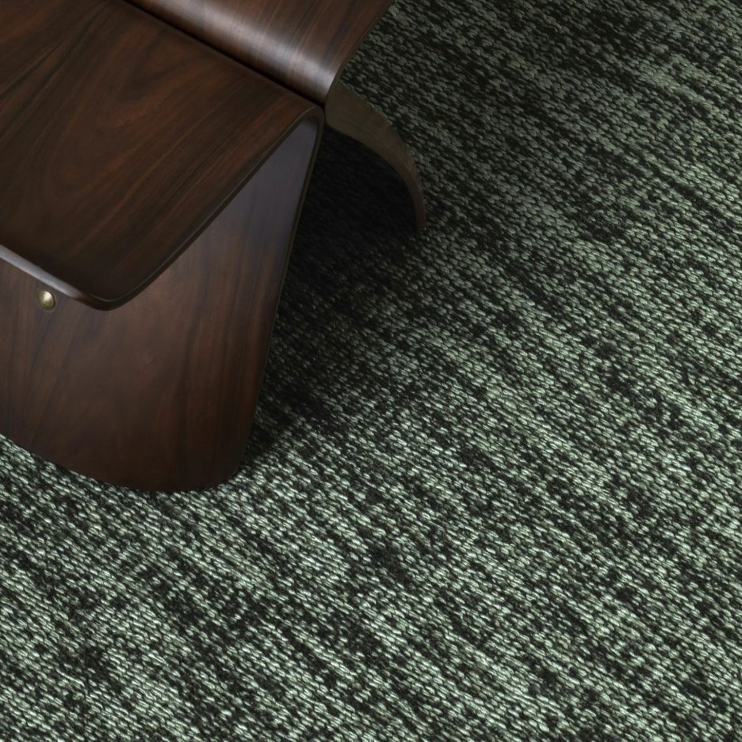 Luce rug style in pale grey and black colored mottled twisted flat weave in a room with a stool