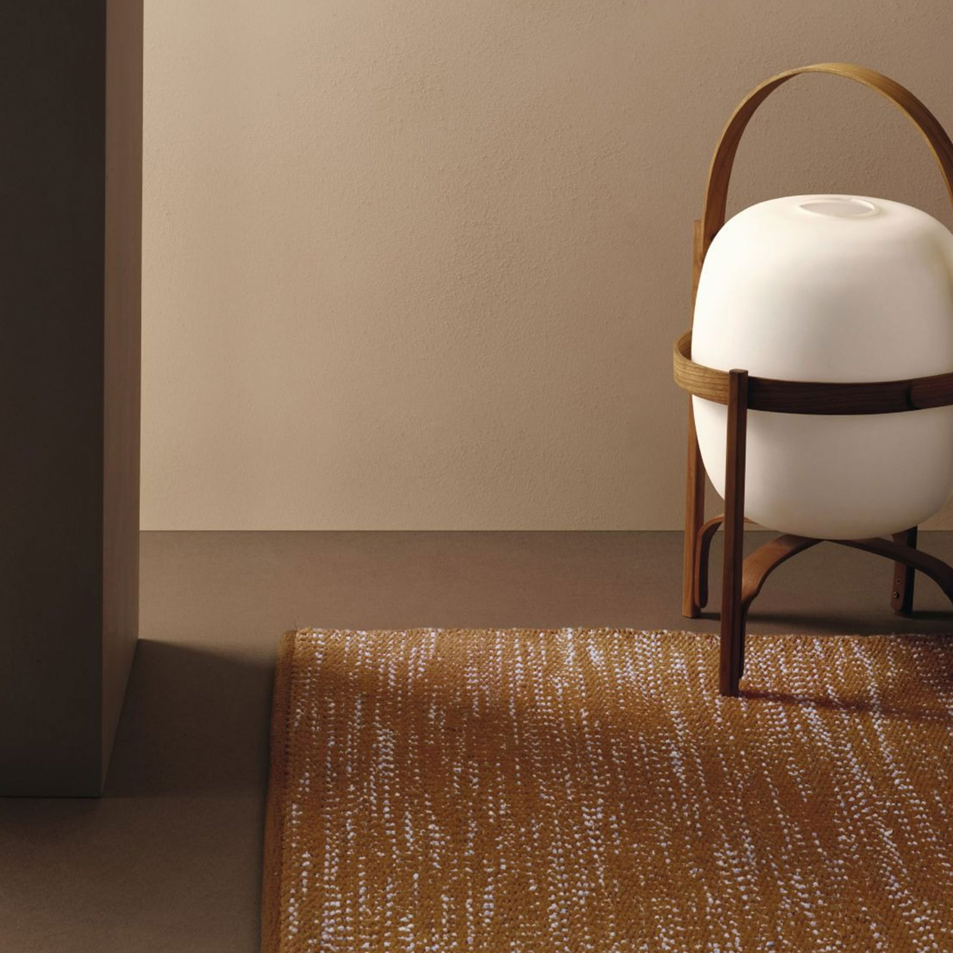 Prato rug style in pale blue and dark terra cotta colored twisted textured flat weave in a room with a Japanes lantern