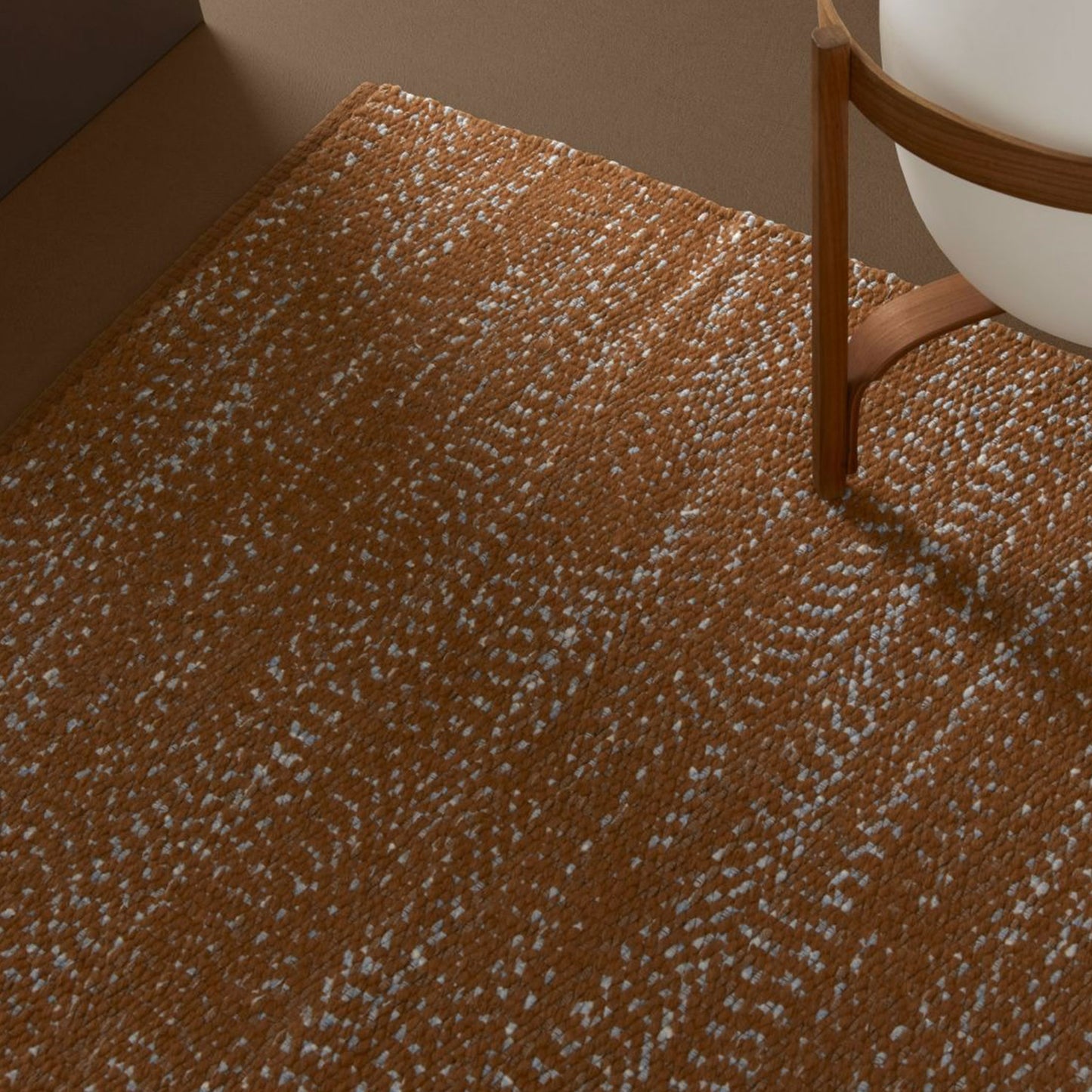 close up of Prato rug style in pale blue and dark terra cotta colored twisted textured flat weave in a room with a Japanese lantern