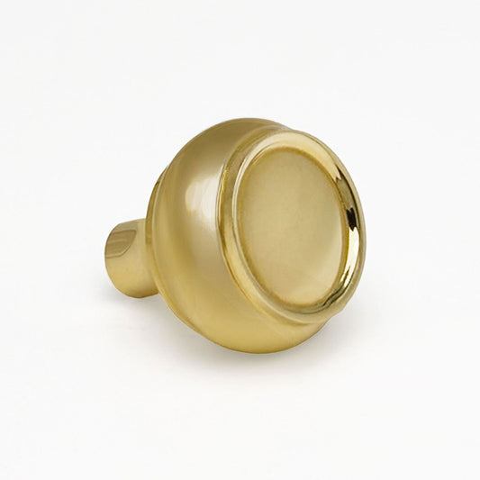 Brass cabinet knob on a white background