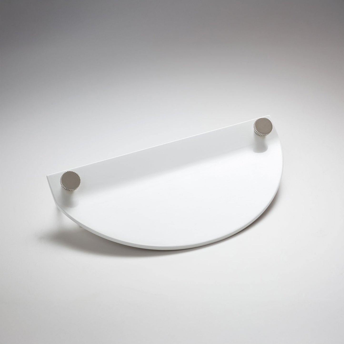 A modern semi-circular metal cabinet pull in a white finish, featuring two small round silver-toned details on the top edges, on a neutral background.