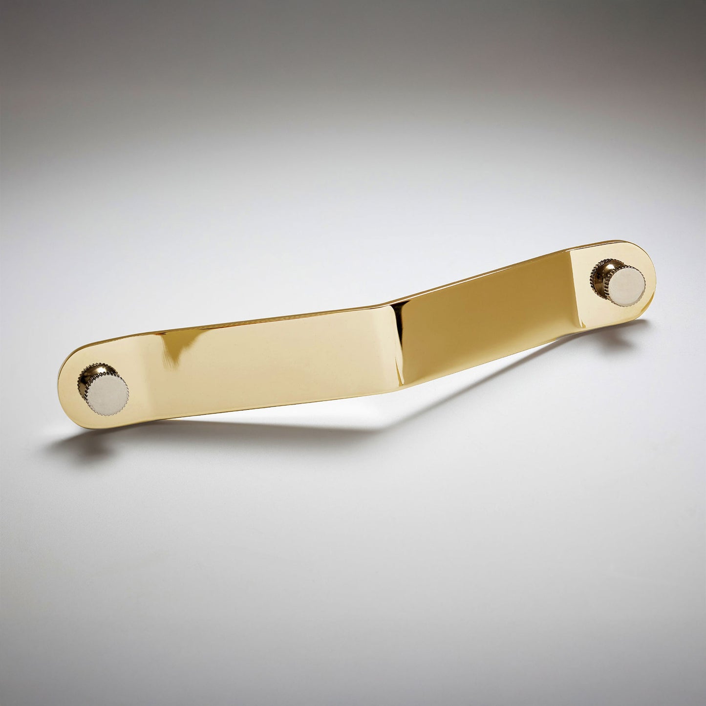 A polished gold-toned brass metal cabinet pull handle with a rectangular bar and circular mounting bases on both ends, on a light gray background.