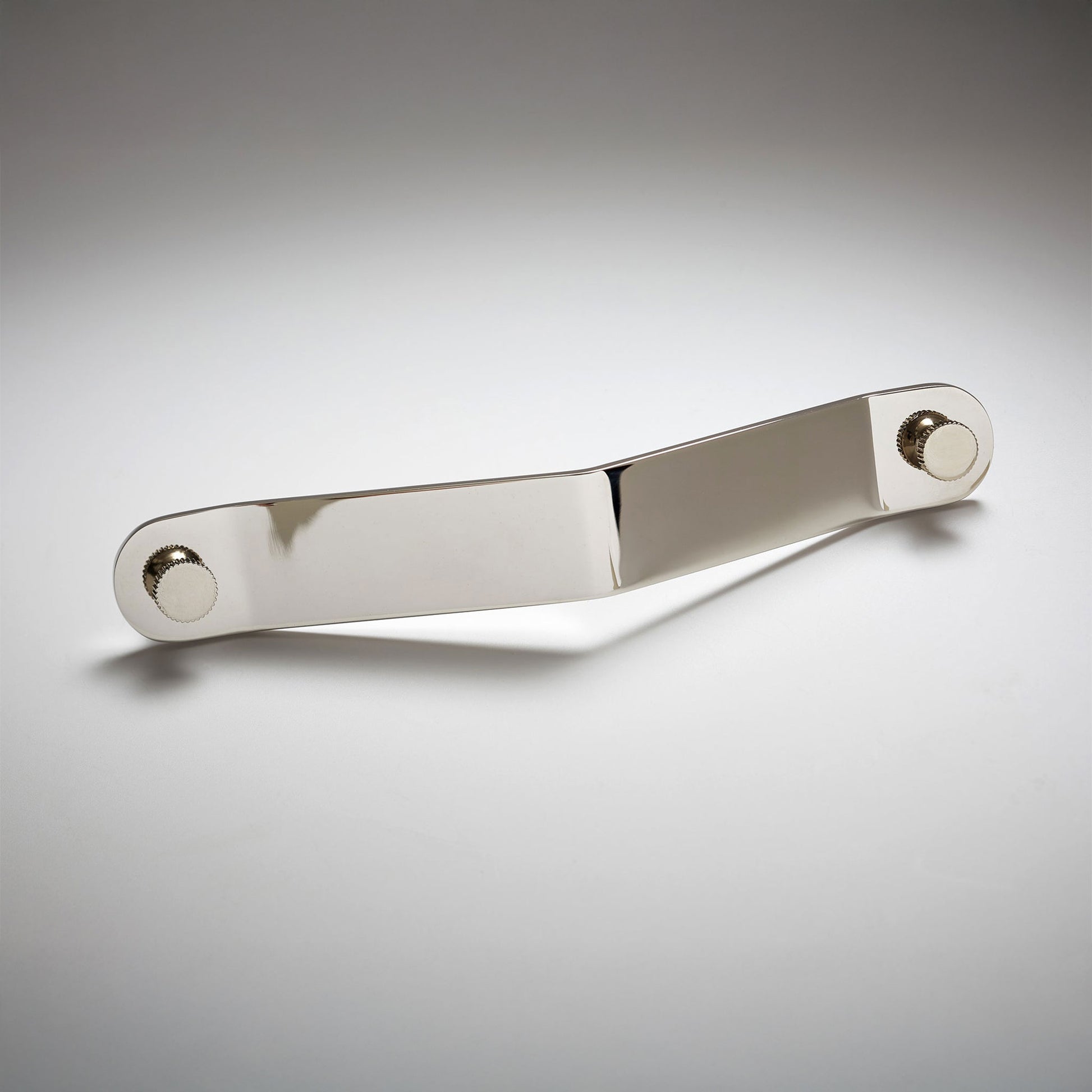 A polished nickel metal cabinet pull handle with a rectangular bar and circular mounting bases on both ends, on a light gray background.