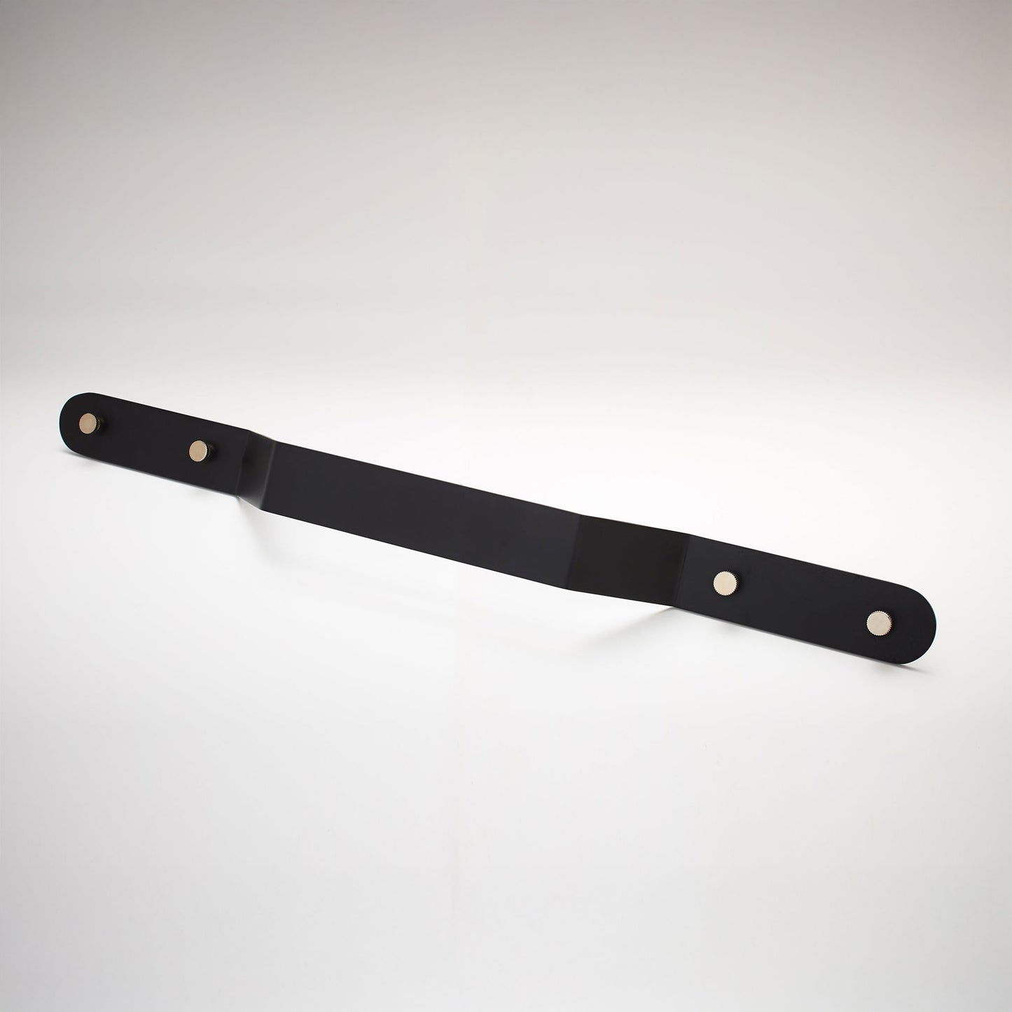 A minimalist, long, black metal cabinet pull handle with two mounting holes, shown on a white background.