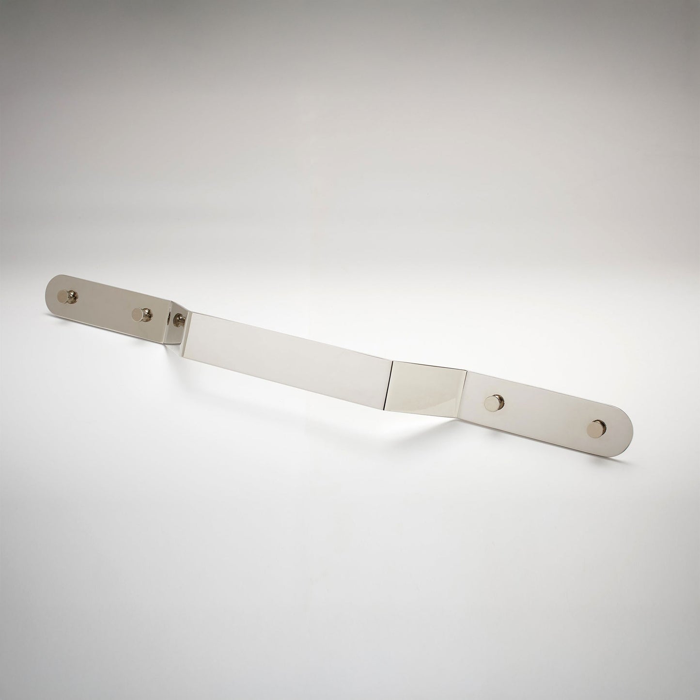 A minimalist, long, polished nickel metal cabinet pull handle with two mounting holes, shown on a white background.