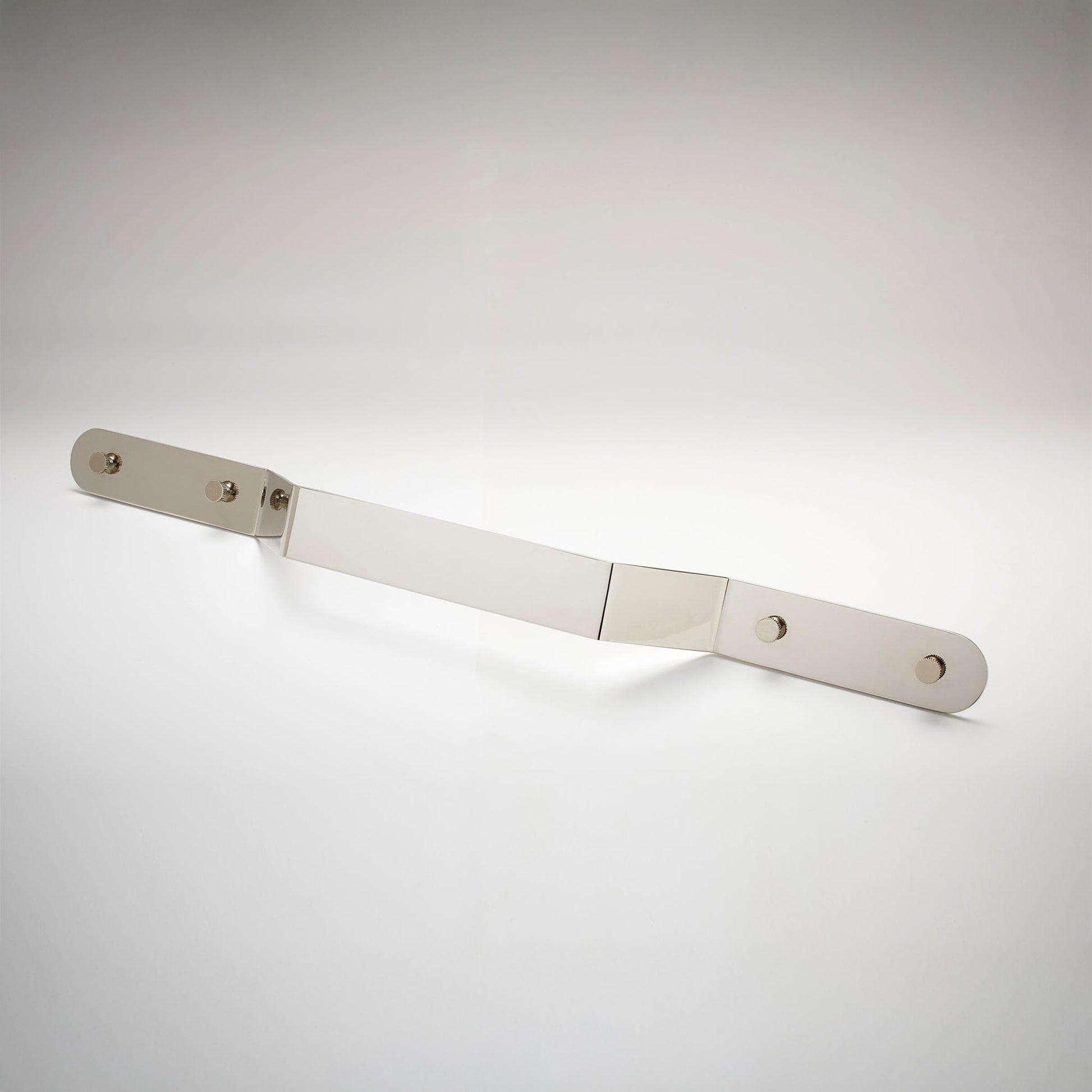 A minimalist, long, polished nickel metal cabinet pull handle with two mounting holes, shown on a white background.