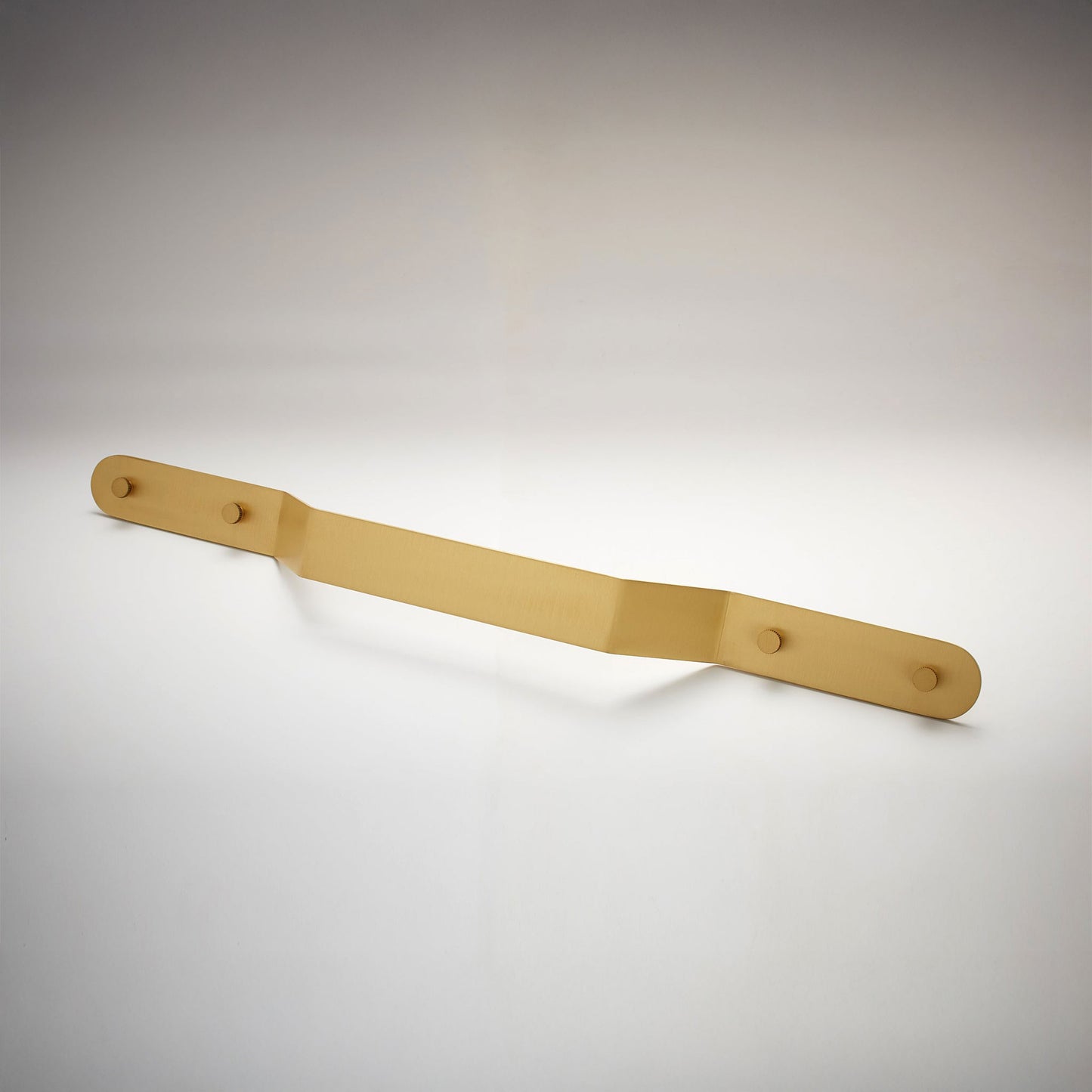A minimalist, matte satin brass metal long cabinet pull handle with two mounting holes, shown on a clean white studio background.