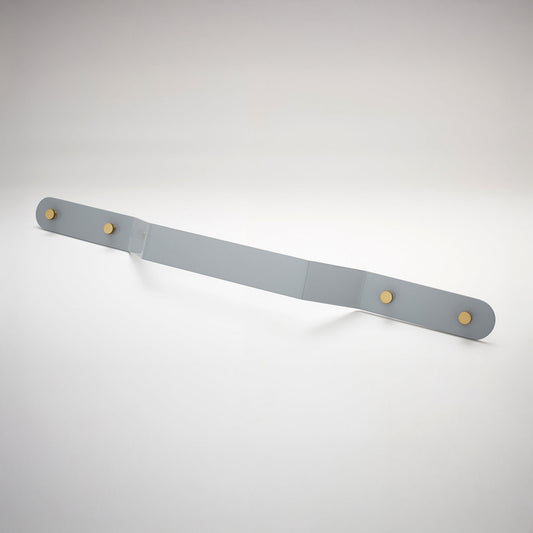A shiny gray powder coated, extra long bent rectangular metal cabinet pull handle with two small, round, brass details on each corner photographed on a white background.