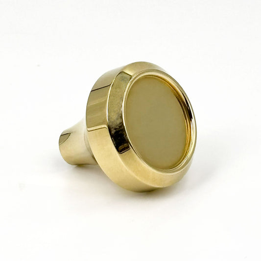 Brass round inset cabinet knob on a white background