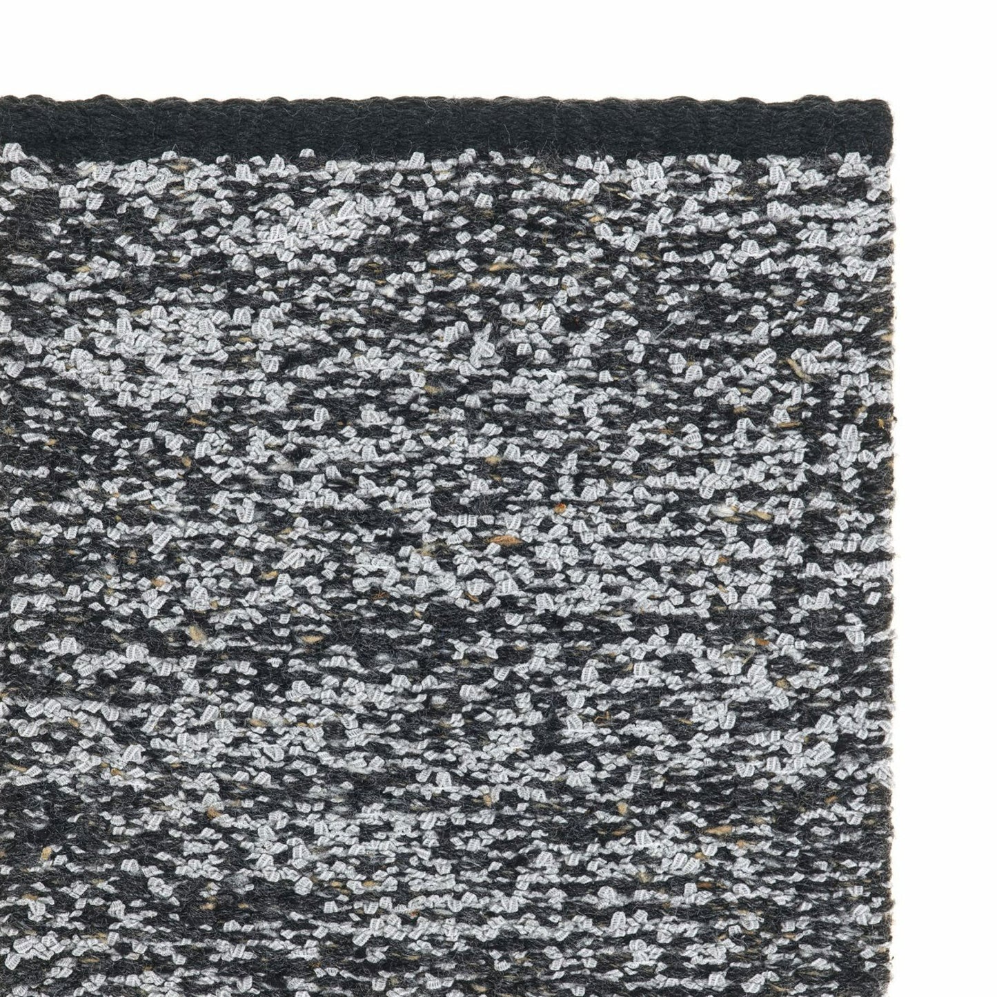 Iris rug style in dove grey and black colored mottled twisted flat weave