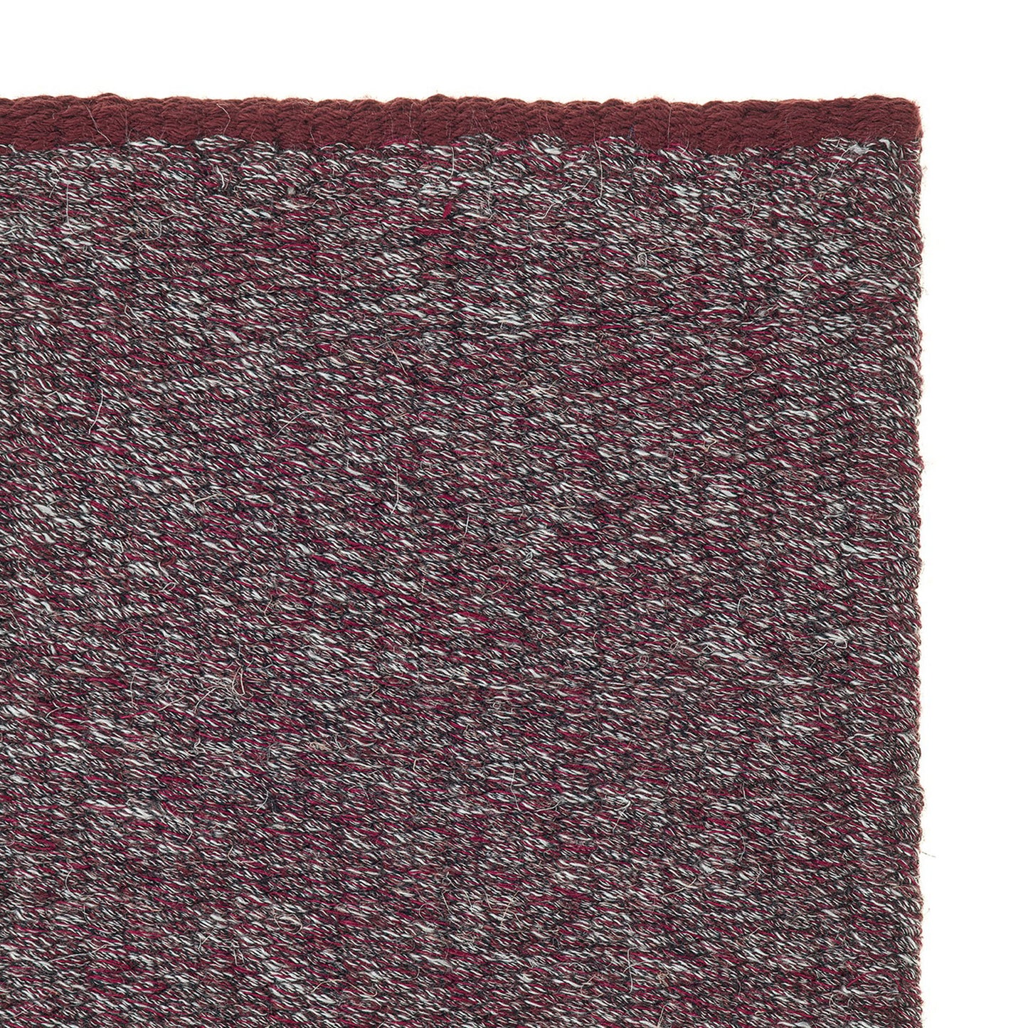 Jaspe rug style in pale grey and garnet colored spun flat weave