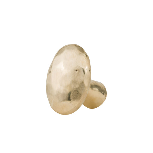 hammered oval brass cabinet knob on a white background