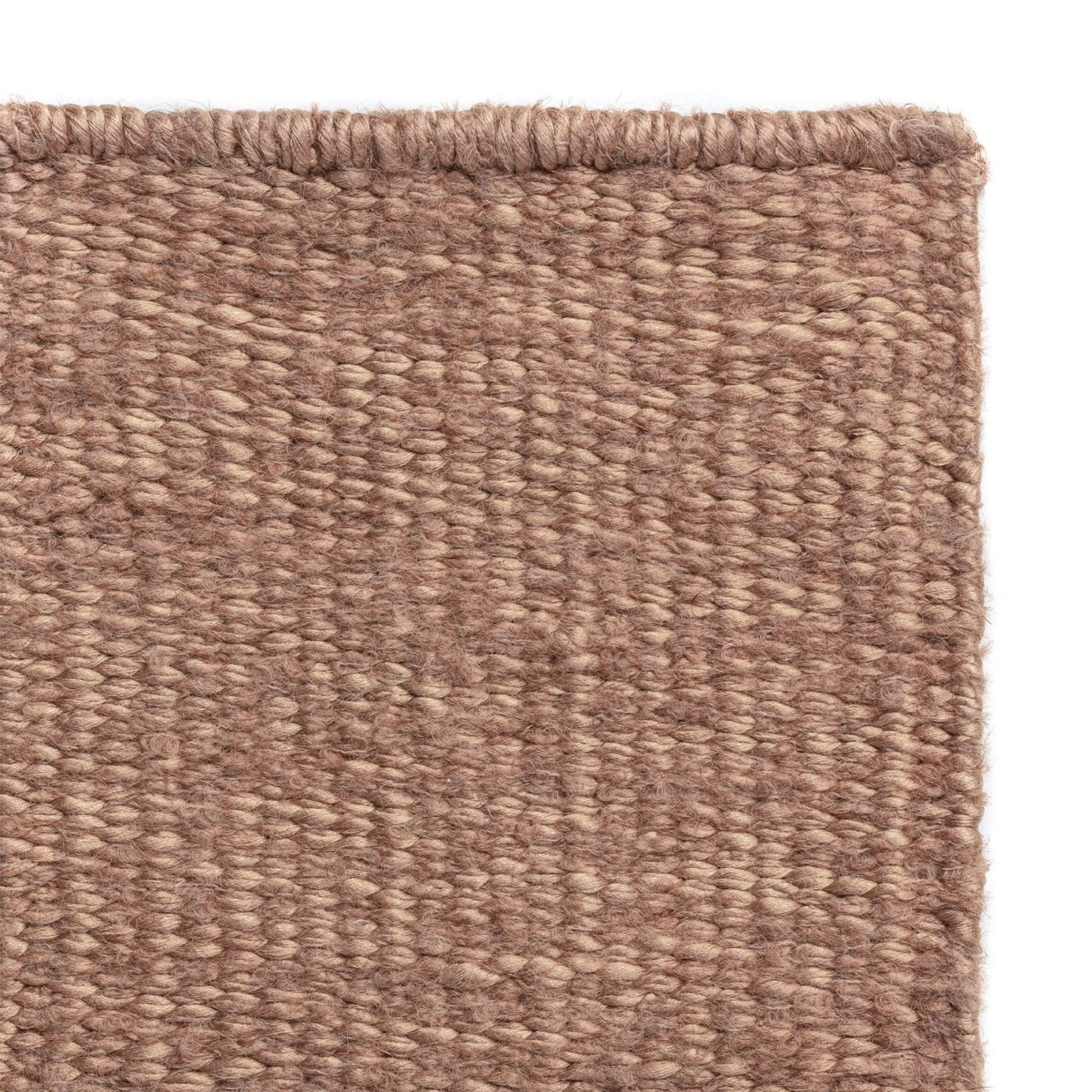 Luce rug style in  palest terra cotta colored mottled twisted flat weave