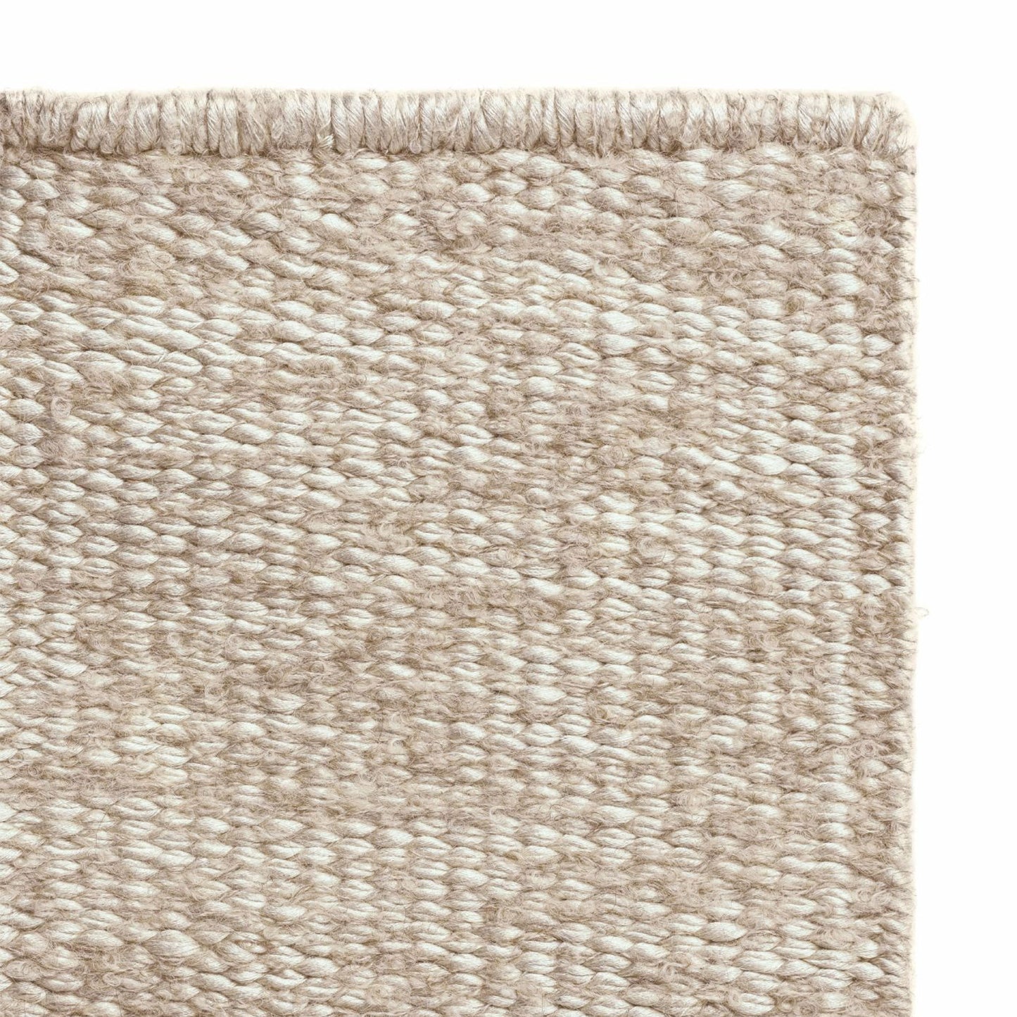 Luce rug style in cream and palest terra cotta colored mottled twisted flat weave