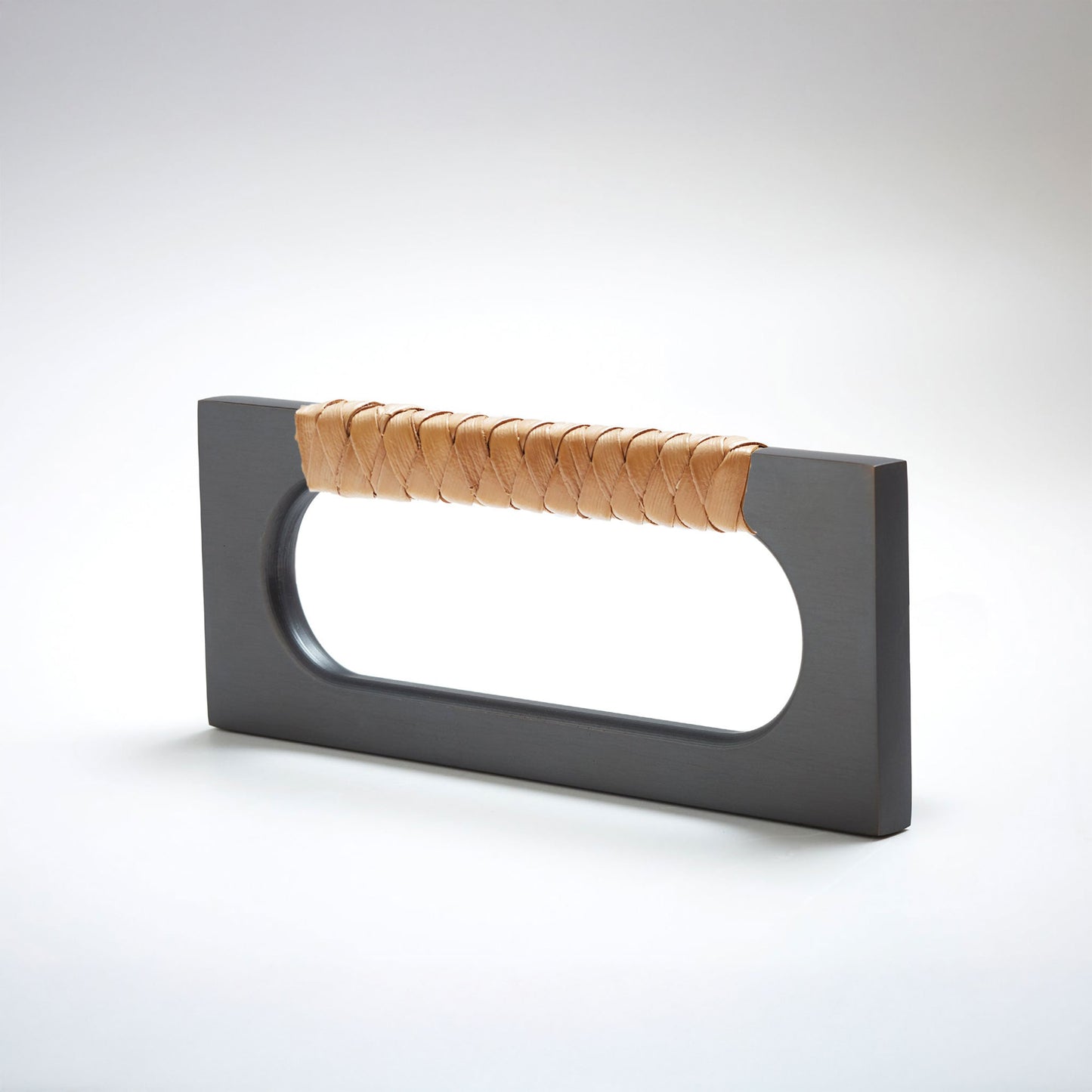 A modern rectangular cabinet pull handle with a dark oil-rubbed bronze finish and a textured woven brown leather handle, shown on a white background.