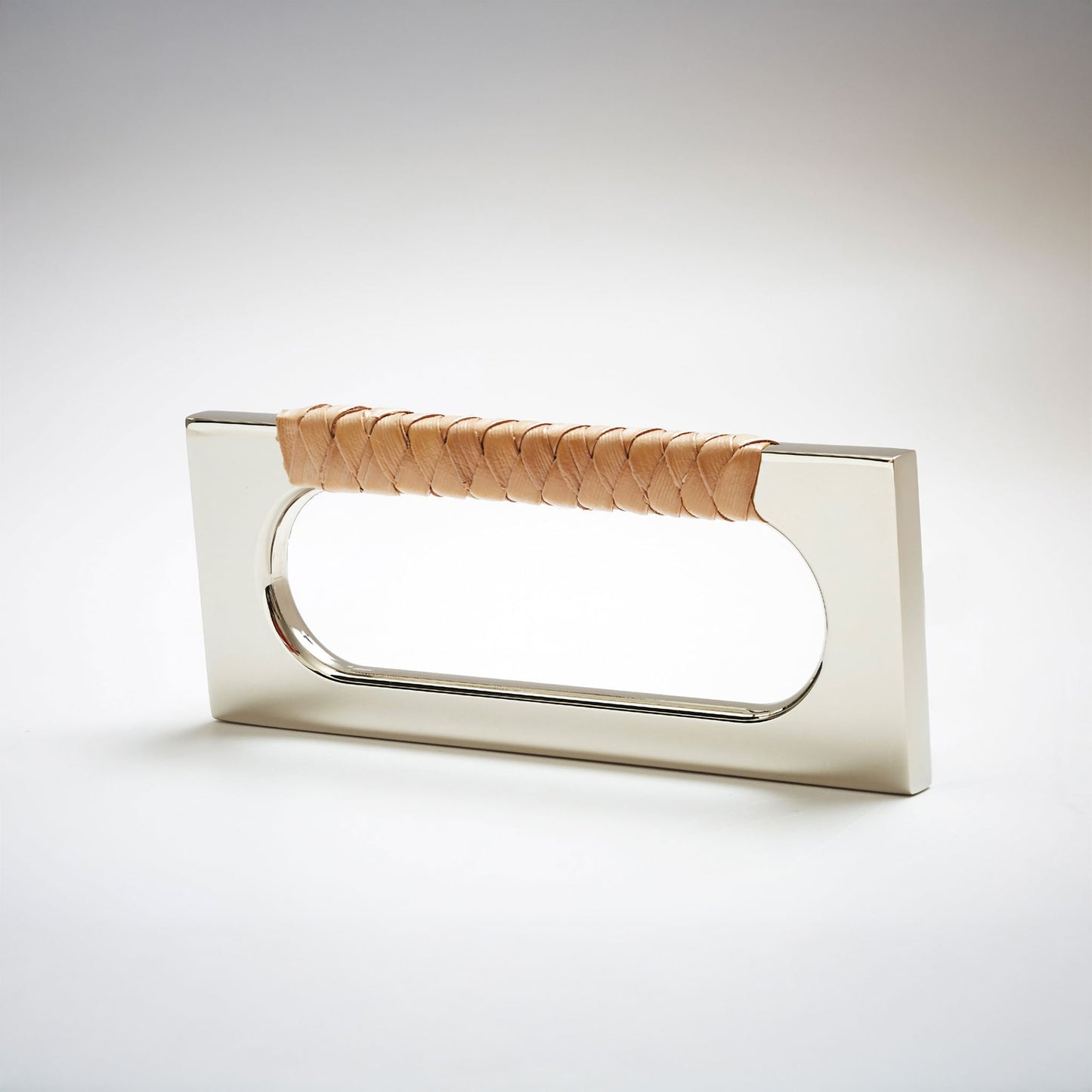 A modern rectangular cabinet pull handle with a polished nickel finish and a textured woven brown leather handle, shown on a white background.
