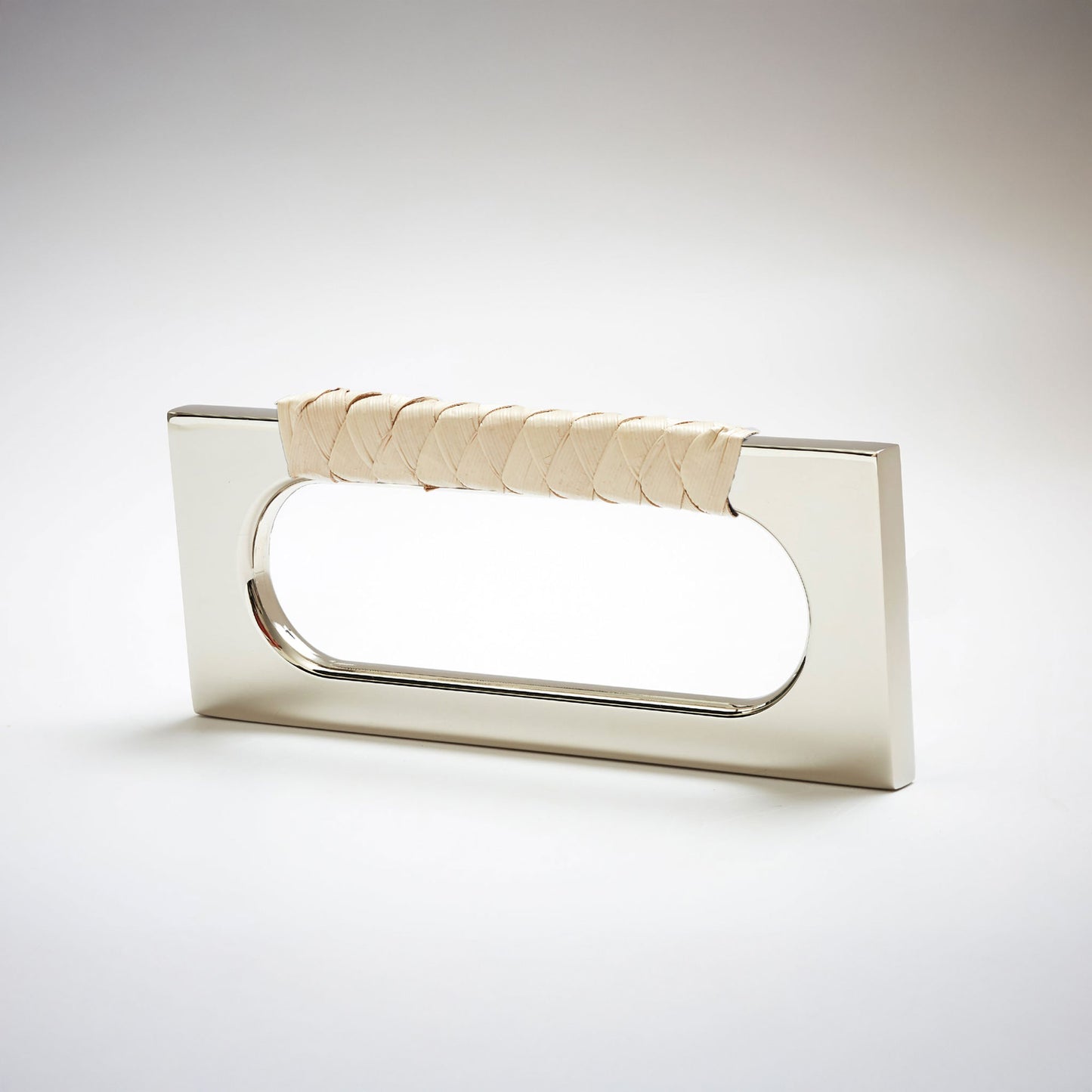 A modern rectangular cabinet pull handle with a polished nickel finish and a textured woven light tan leather handle, shown on a white background.