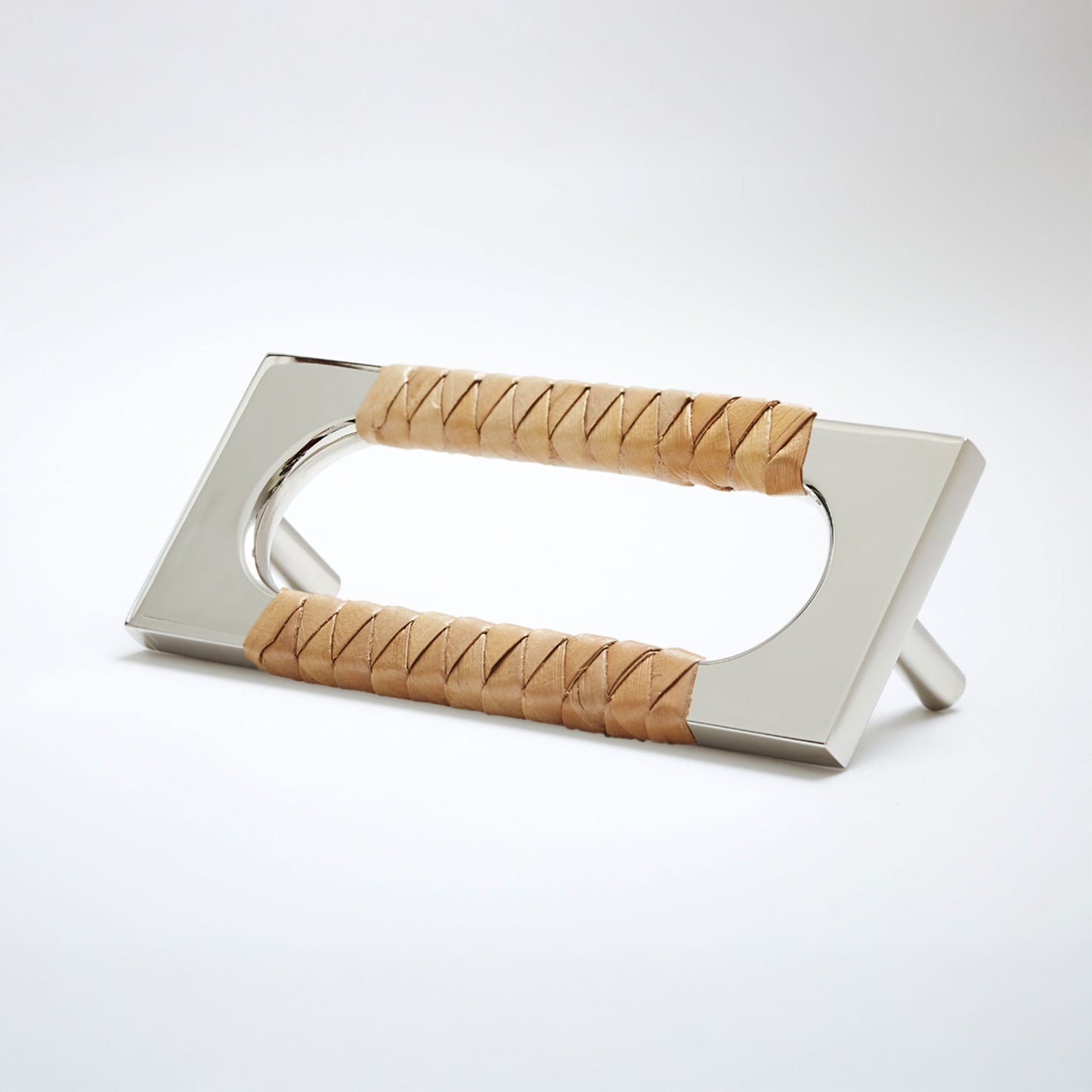 A modern polished nickel cabinet pull handle with an oval cutout, wrapped with a natural brown screwpine leaf reed,  shown on a white background.