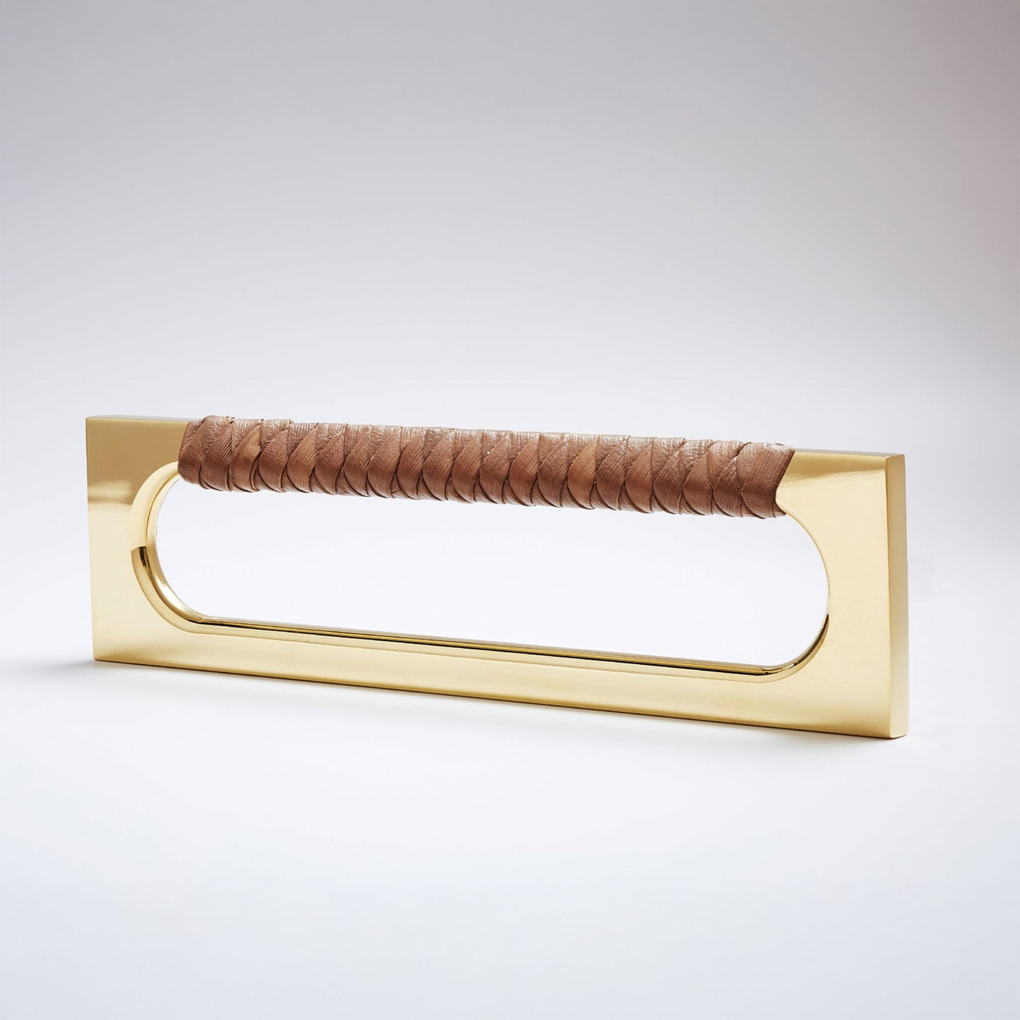 A modern long rectangular cabinet pull handle featuring a polished brass metal frame and a textured brown braided pine grip, shown on a white background.