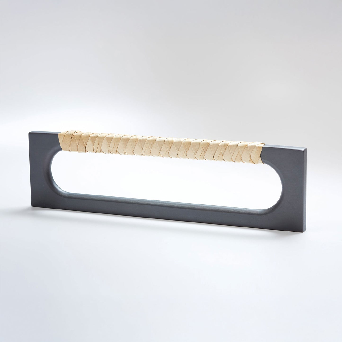 A modern long rectangular cabinet pull handle featuring a dark oil-rubbed bronze metal frame and a textured light natural tan braided pine grip, shown on a white background.