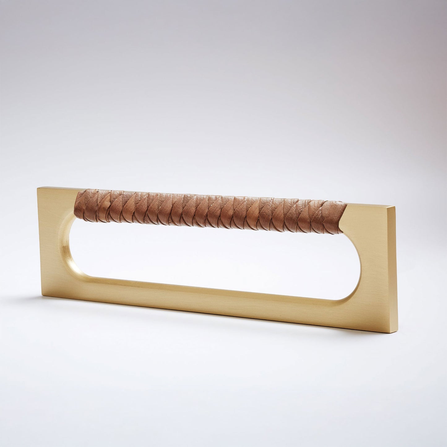 A modern long rectangular cabinet pull handle featuring a satin brass metal frame and a textured dark natural brown braided pine grip, shown on a white background.