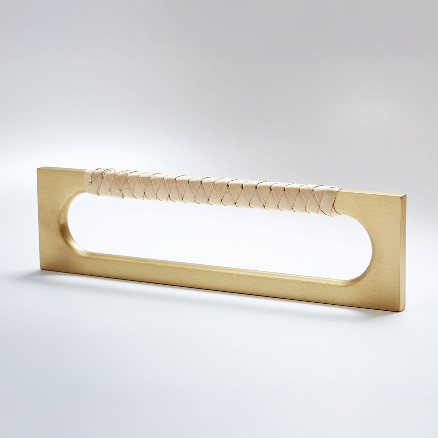 A modern long rectangular cabinet pull handle featuring a satin brass metal frame and a textured light tan braided pine grip, shown on a white background.