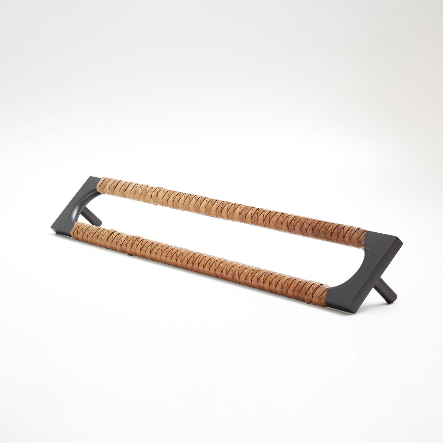 A modern long rectangular cabinet pull handle with a dark oil-rubbed bronze metal frame with an oval shaped-cutout and a brown leather woven grip, shown on a white background.