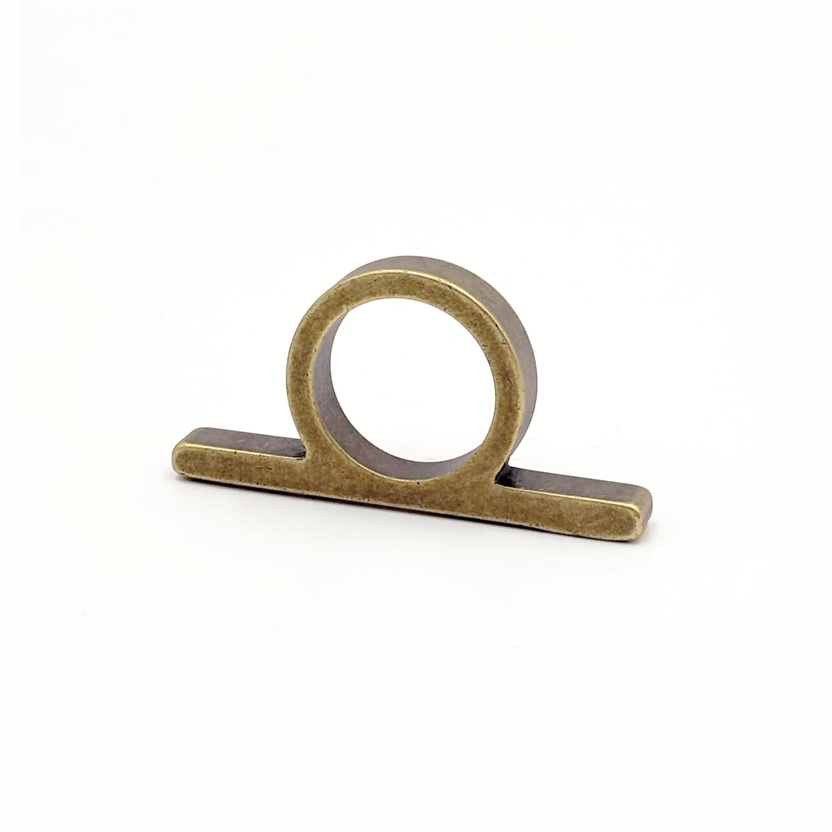 Top View of an antique bronze metal ring pull with a circular loop and flat rectangular base, shown on a plain white background.