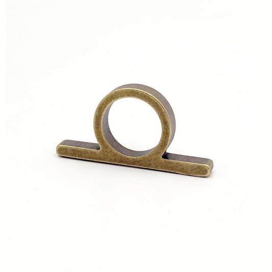 Top View of an antique bronze metal ring pull with a circular loop and flat rectangular base, shown on a plain white background.