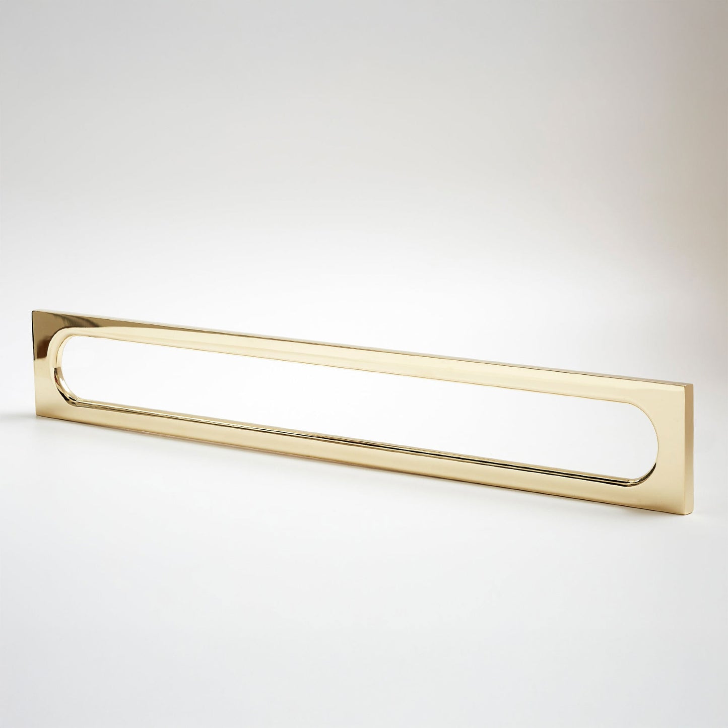 A long, narrow rectangular metak cabinet pull with a rounded rectangular cutout in the center, photographed on a clean light gray studio background.