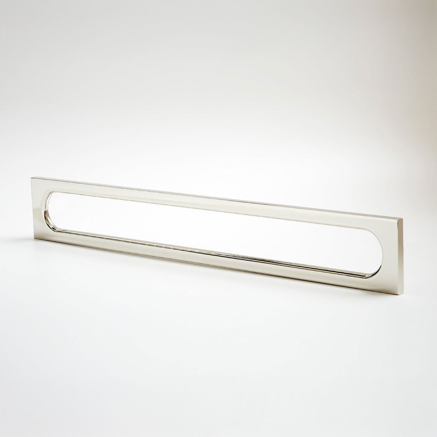 A long, narrow rectangular metak cabinet pull with a rounded rectangular cutout in the center, photographed on a clean light gray studio background.