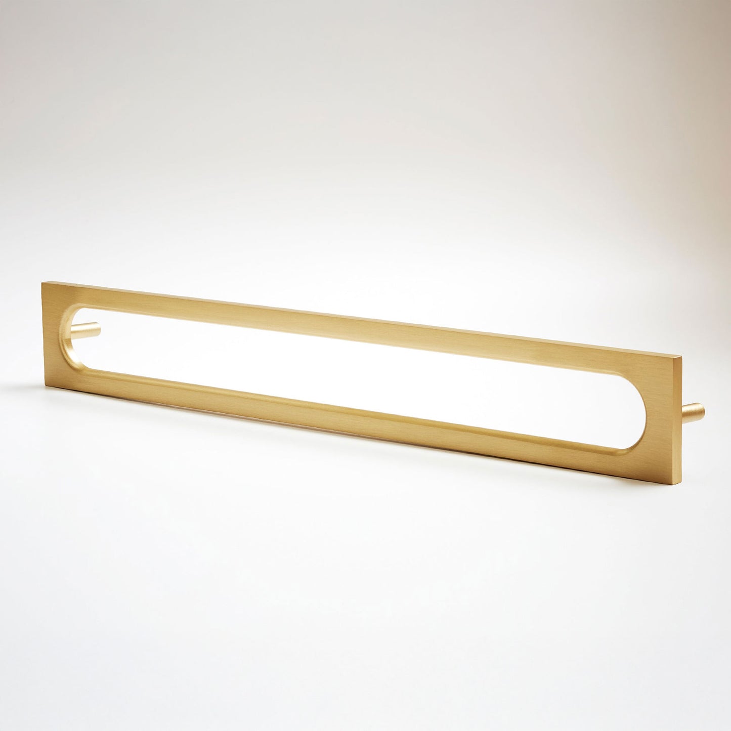 A long, narrow rectangular metal cabinet pull with a rounded rectangular cutout in the center, photographed on a clean light gray studio background.